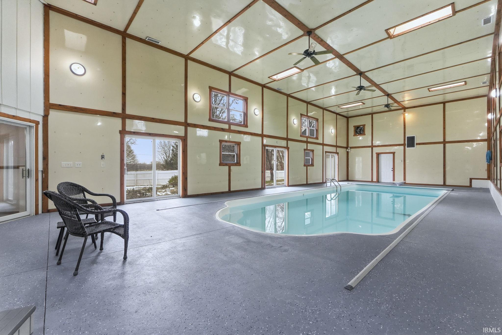 View of swimming pool with ceiling fan