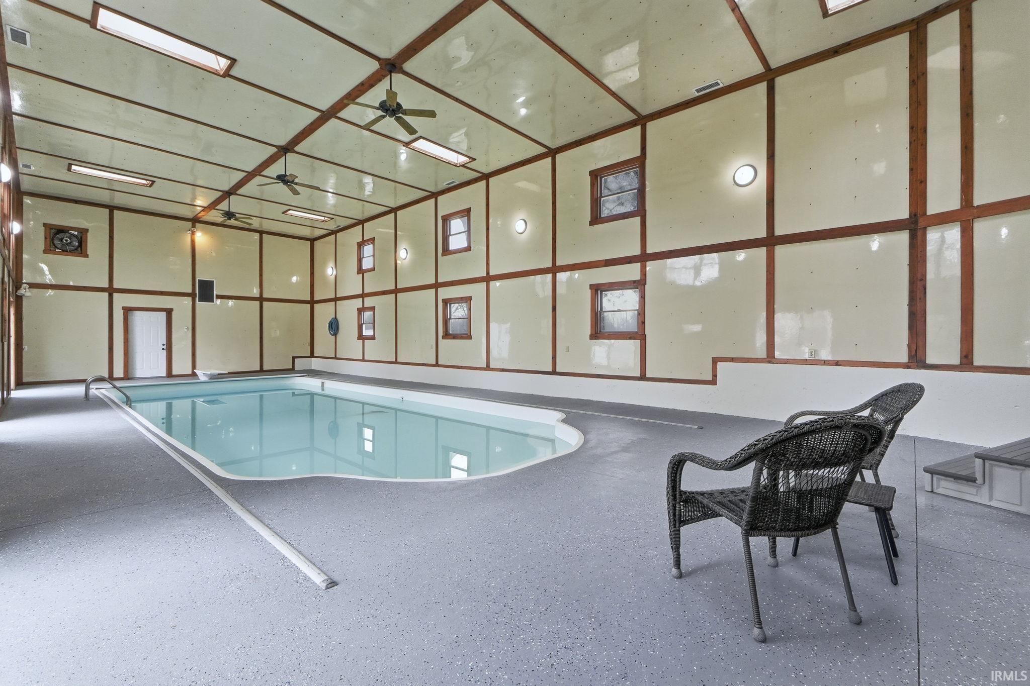 Indoor pool with a ceiling fan