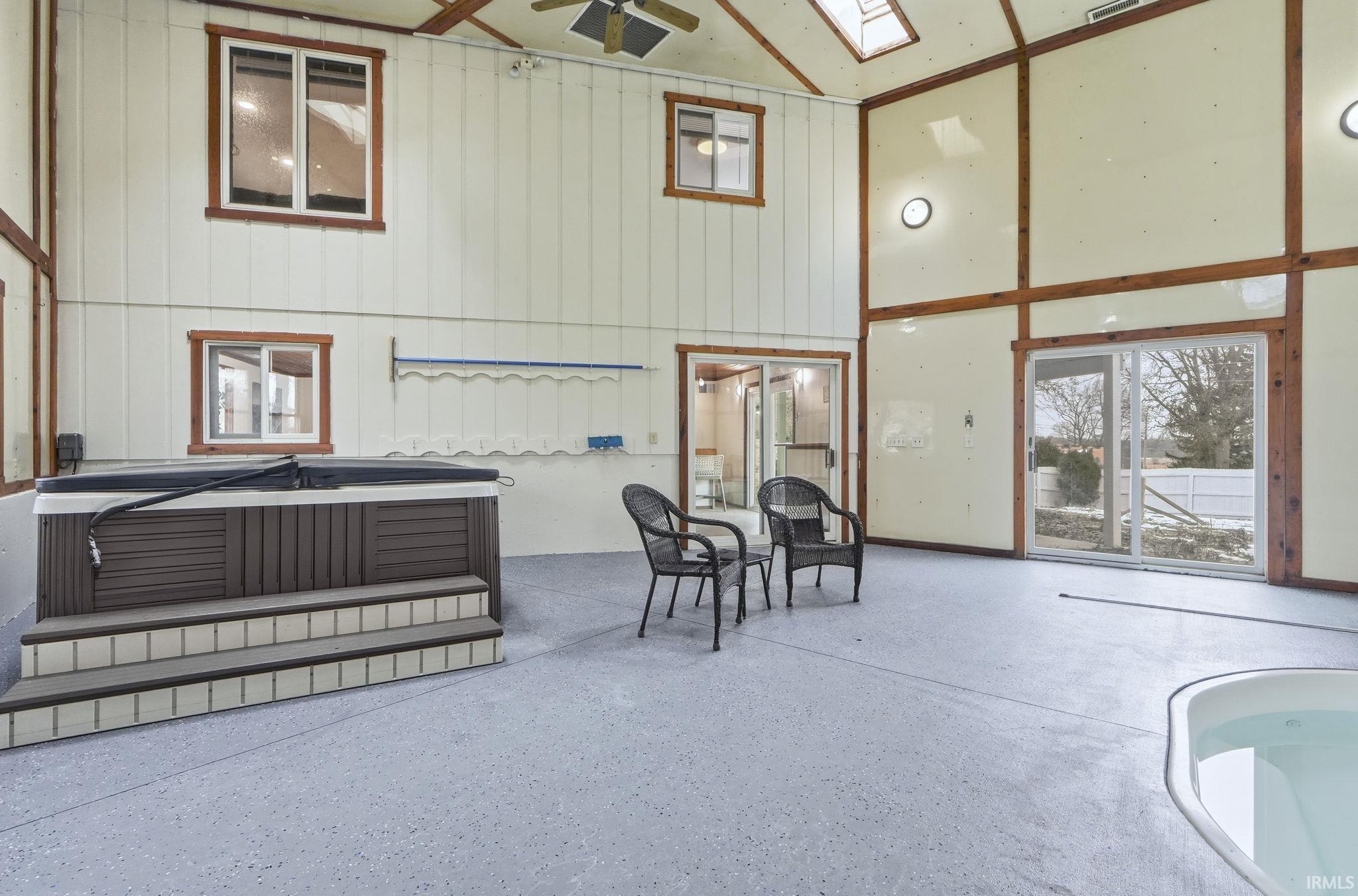 Interior space featuring a hot tub and ceiling fan