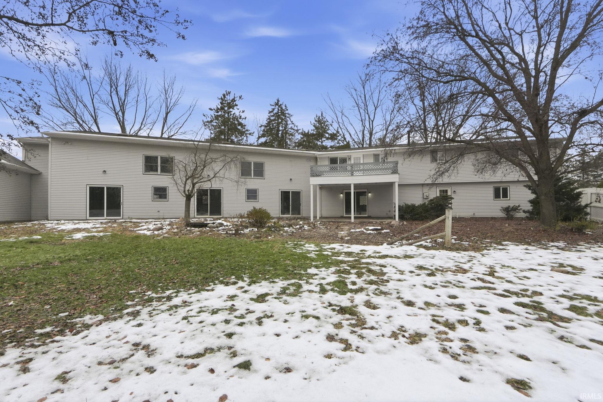 Snow covered property with a patio