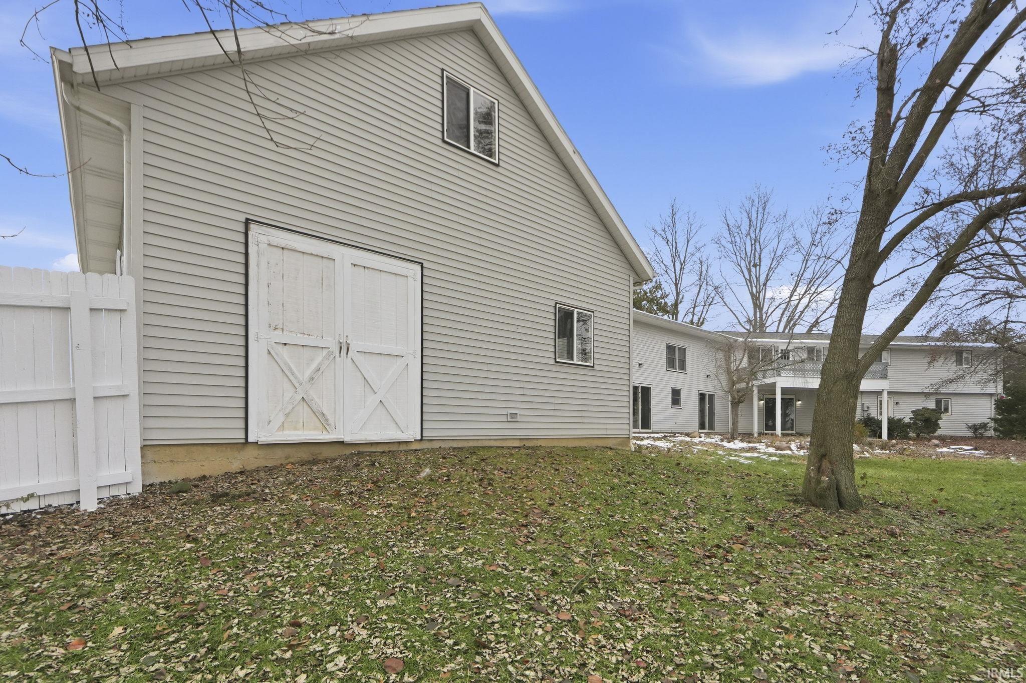 Rear view of house featuring a lawn