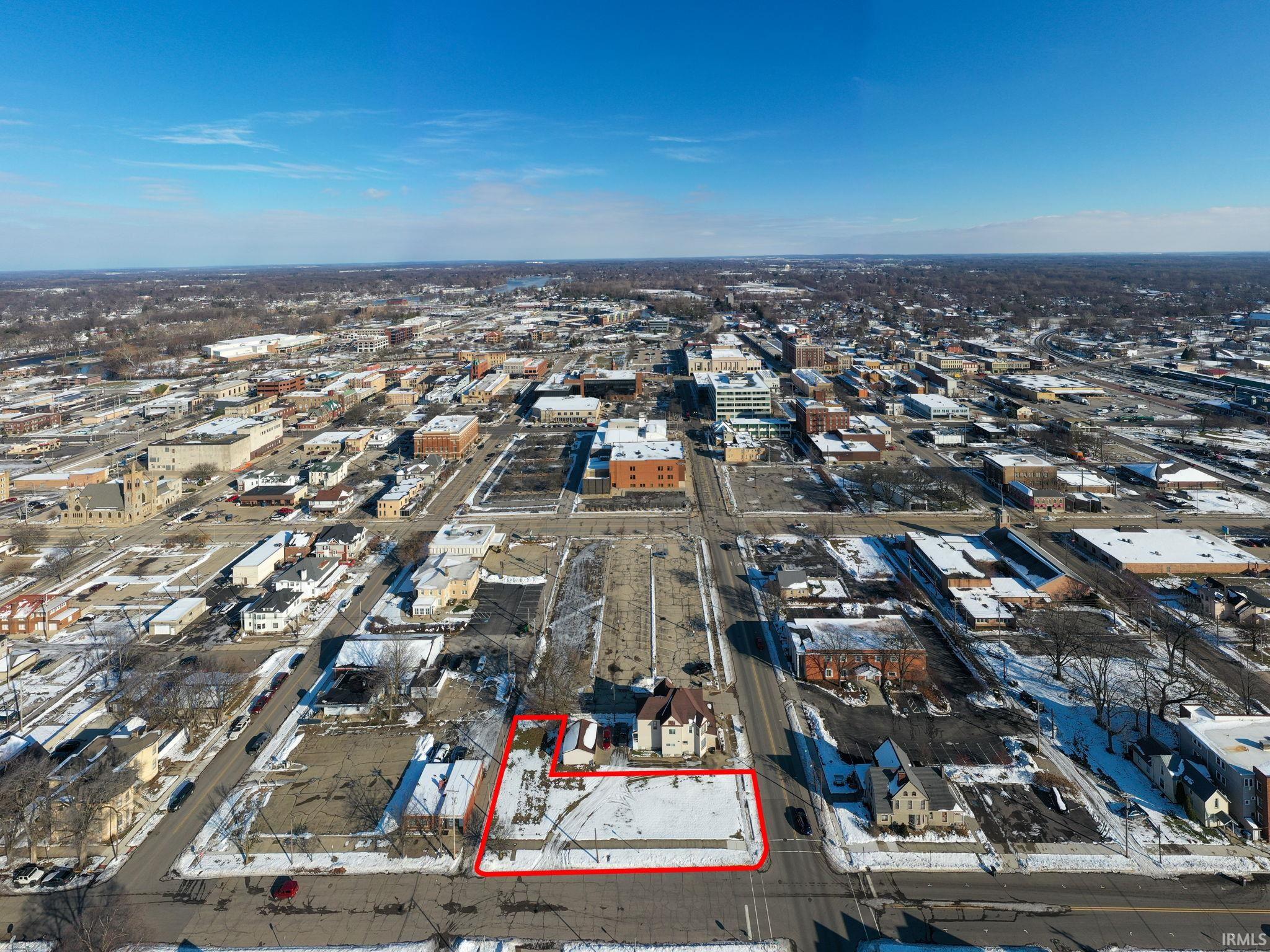 Aerial view of property's location featuring nearby urban area and property boundaries highlighted
