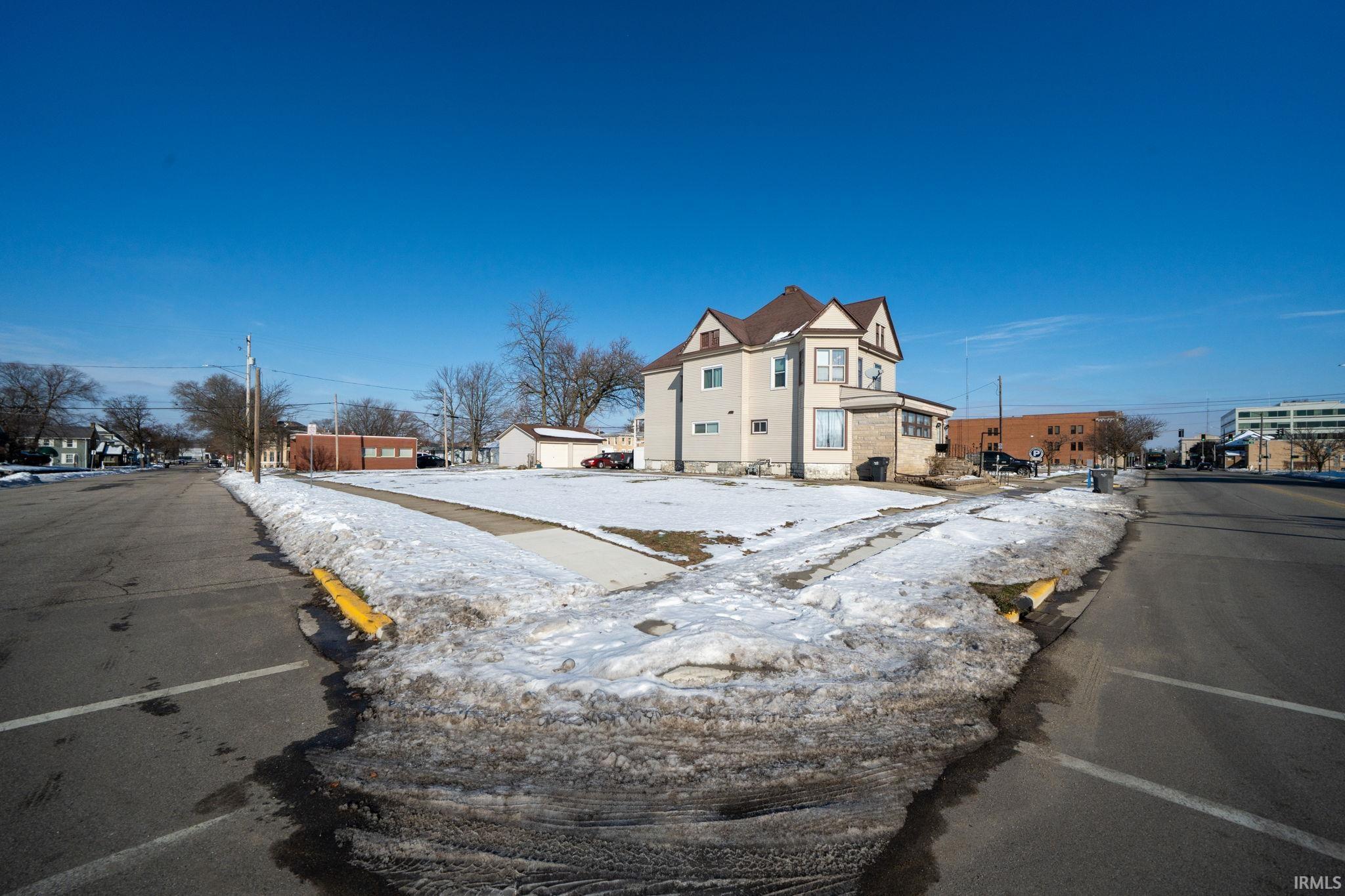 View of asphalt street featuring a residential view