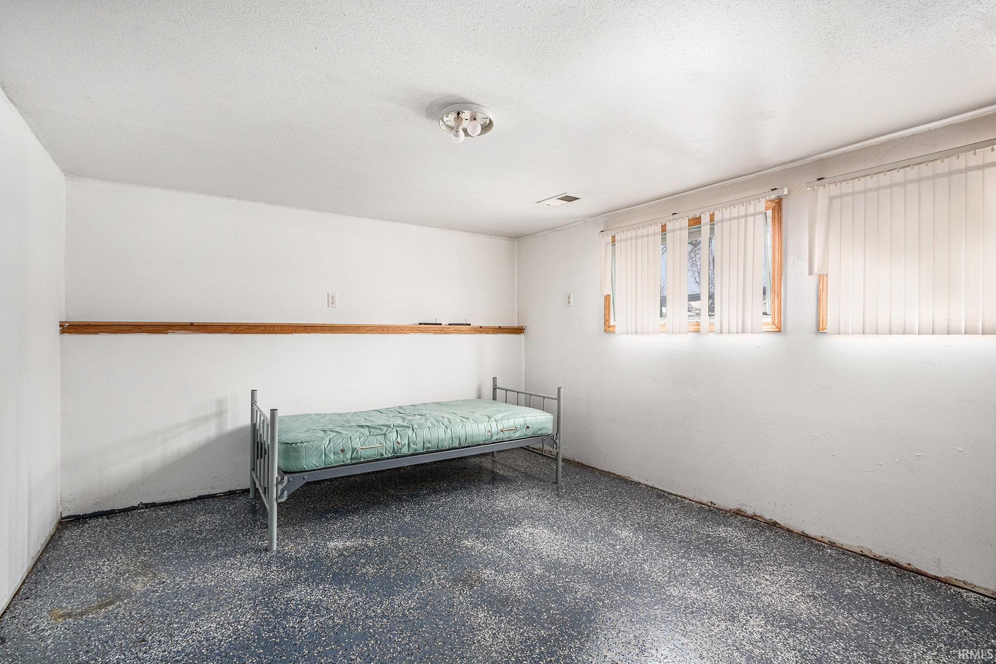 Bedroom featuring a textured ceiling