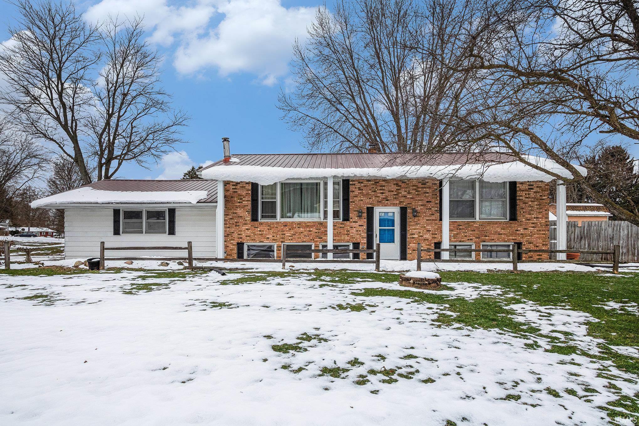 Bi-level home featuring brick siding and a chimney