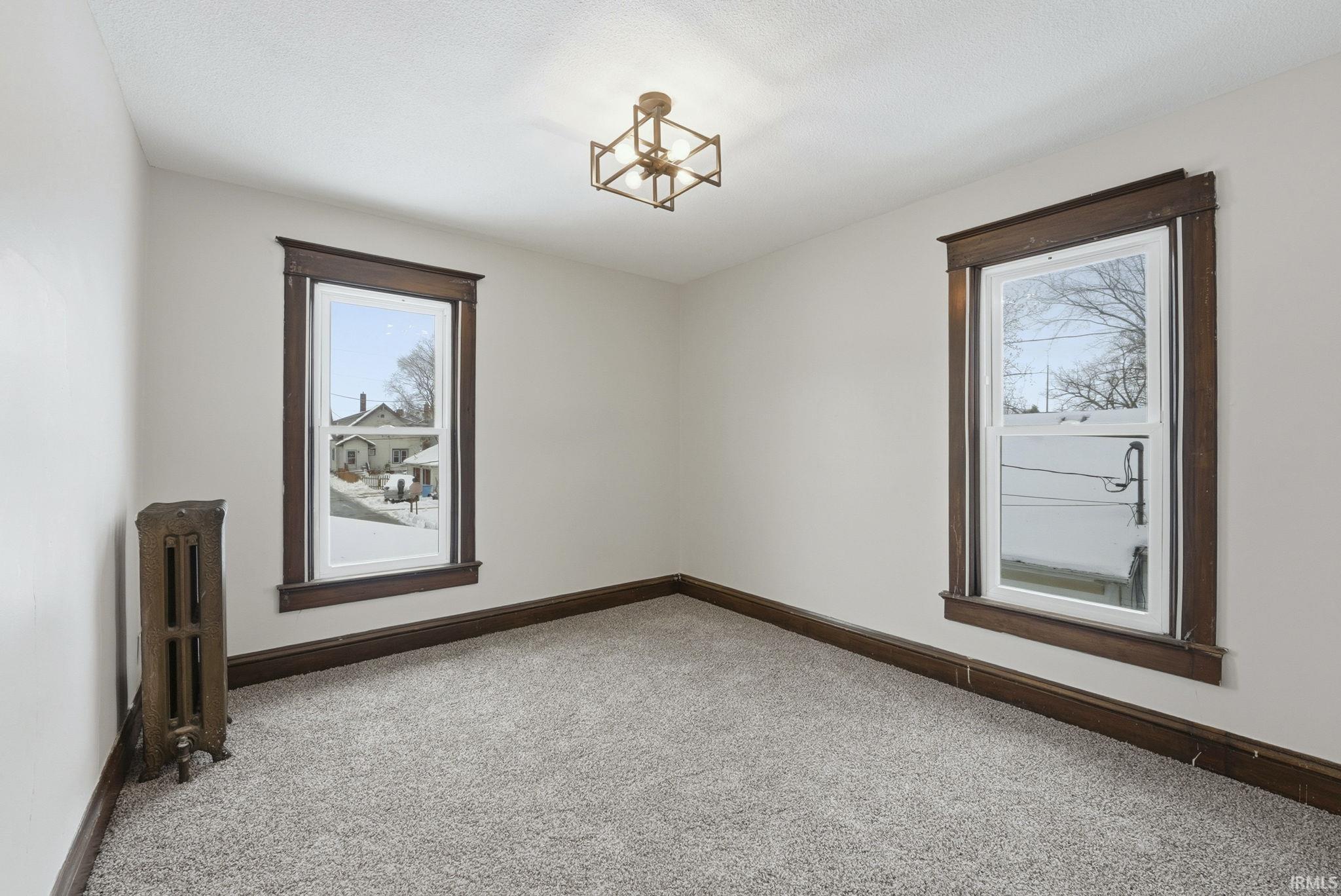 Spare room with radiator and carpet floors
