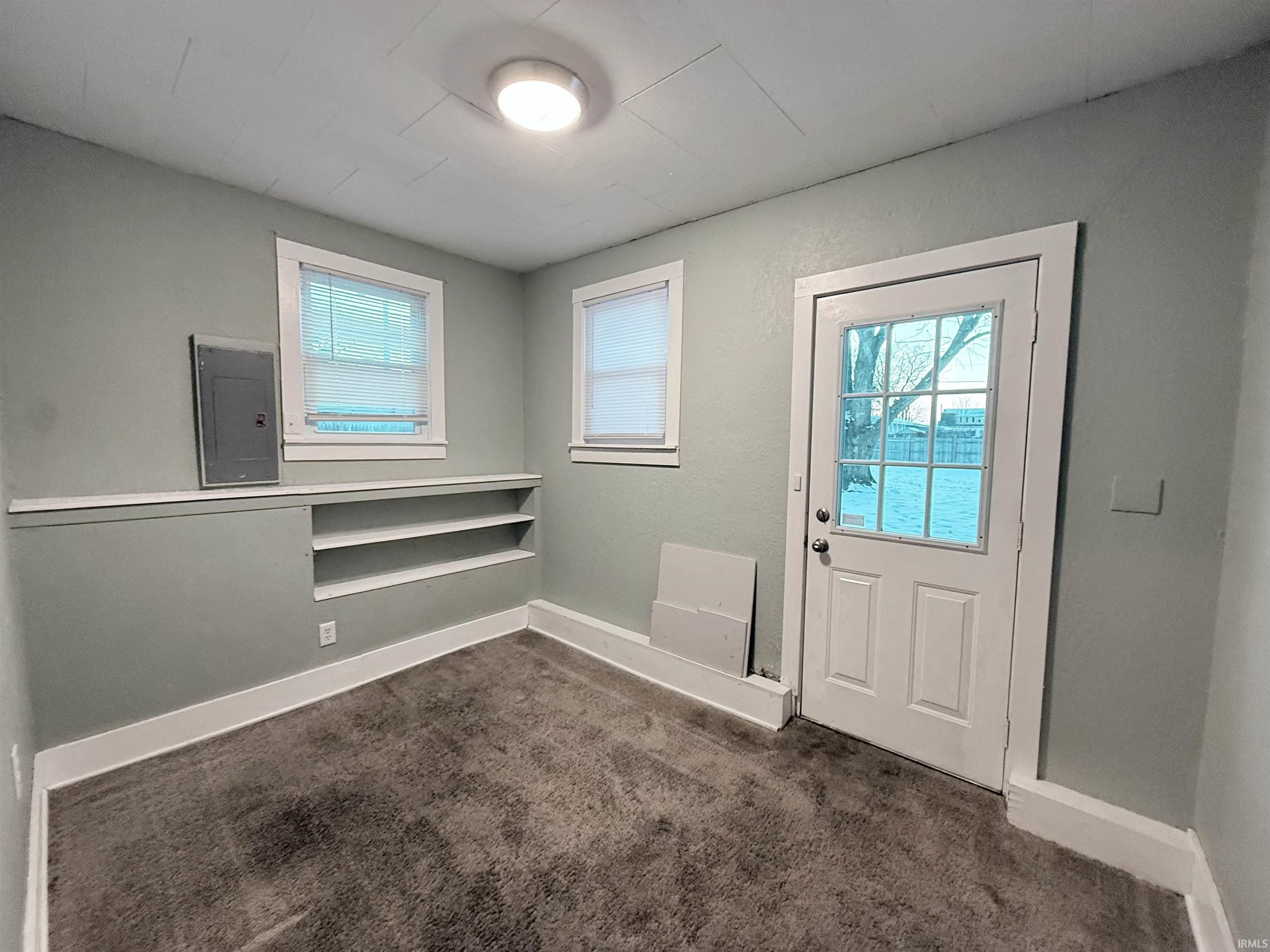 Doorway with electric panel and carpet