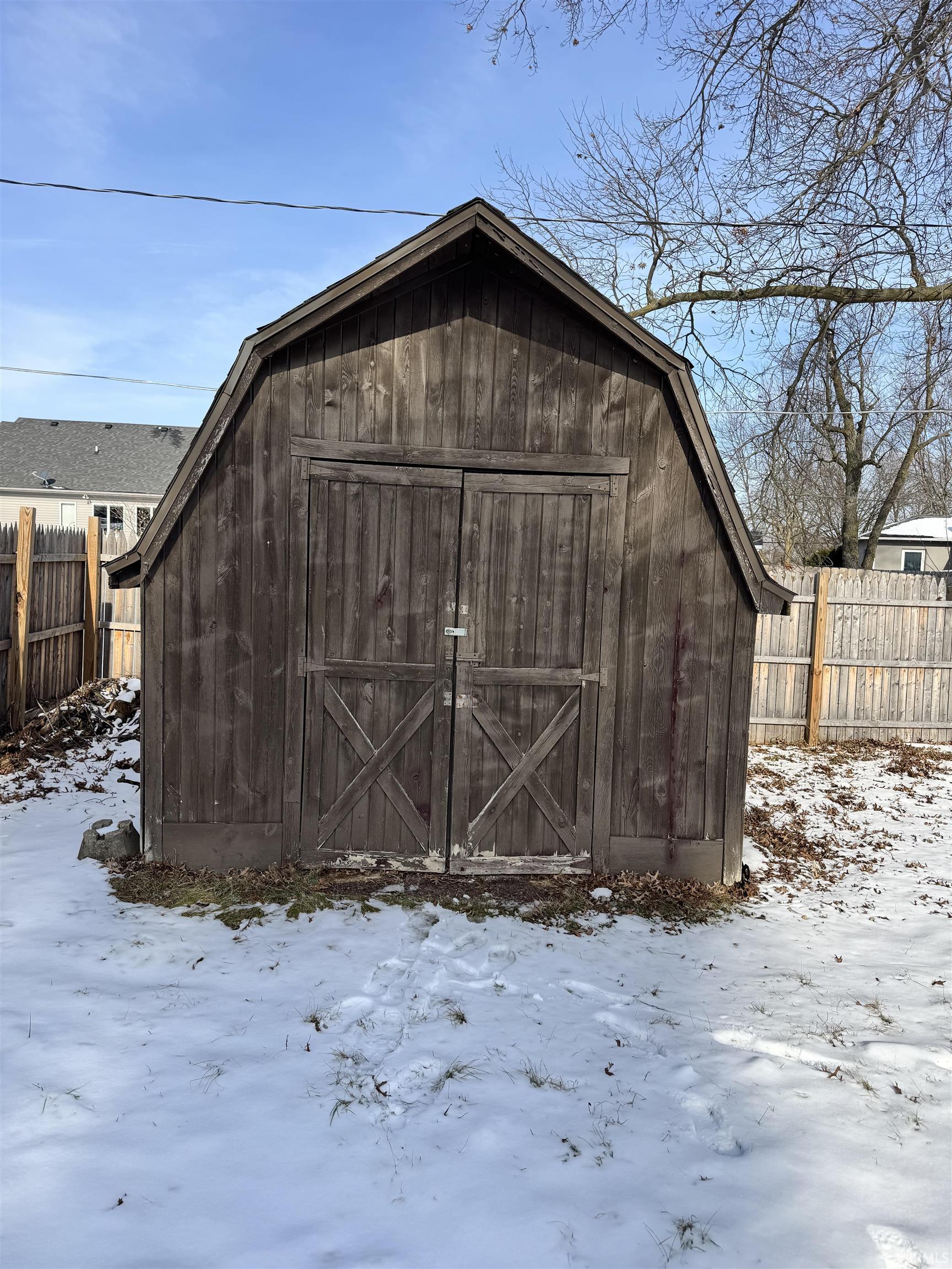 Snow covered structure with a storage shed