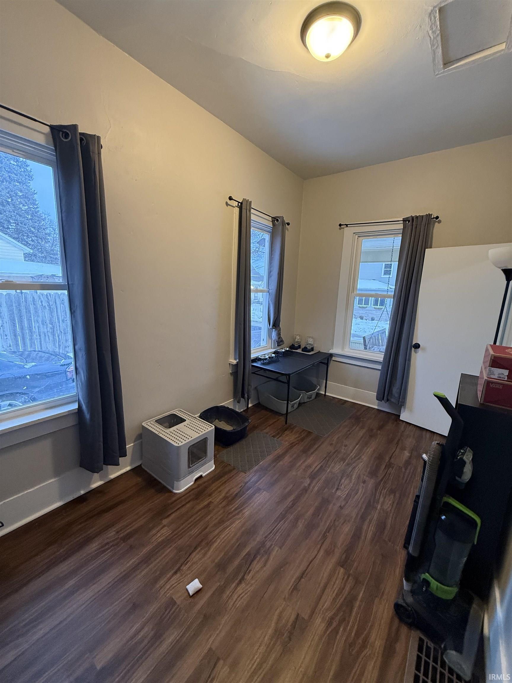 Bedroom featuring dark wood-type flooring and attic access