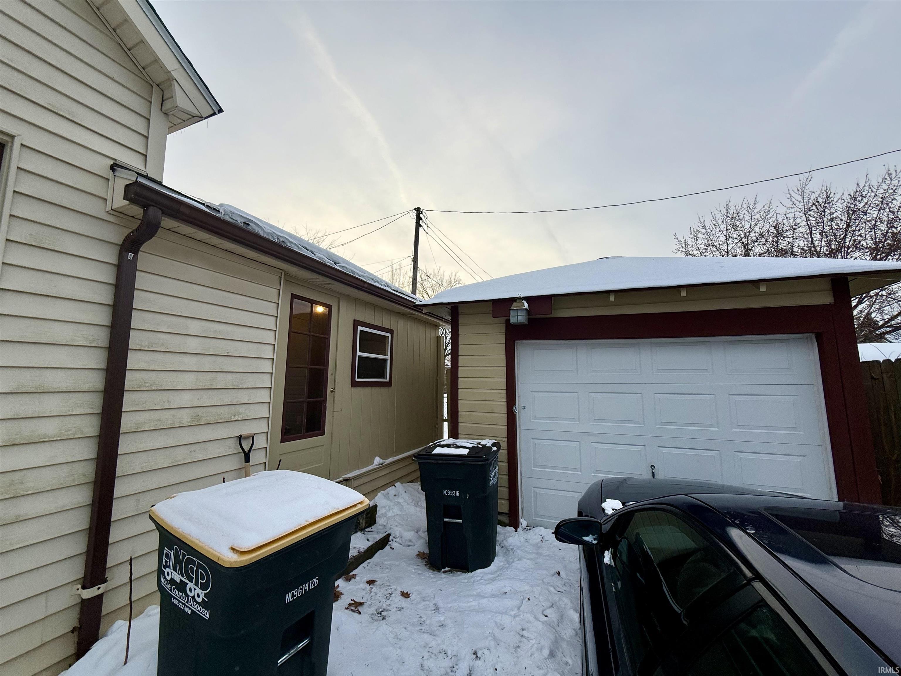 View of property exterior with an outdoor structure