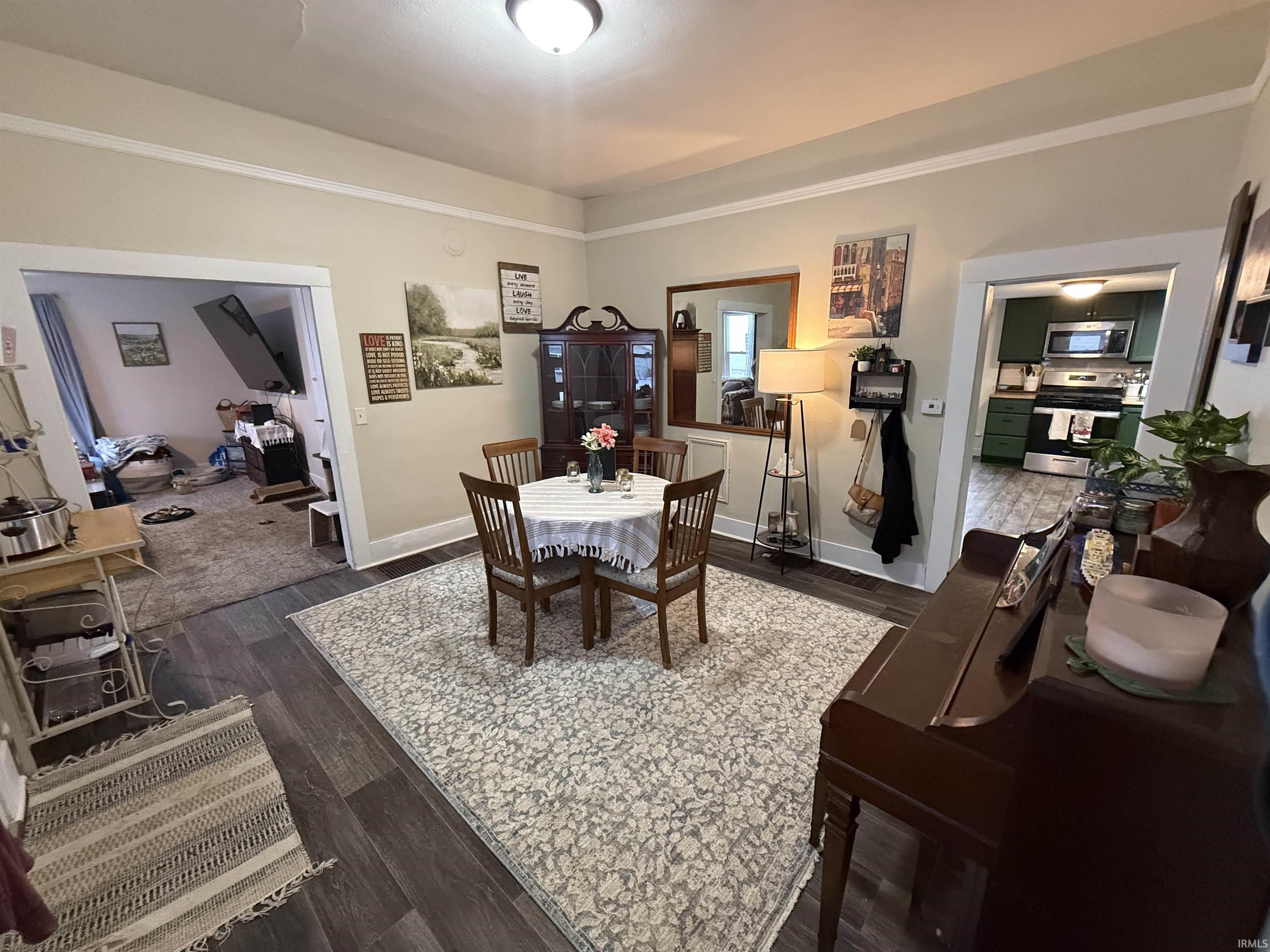 Dining room with dark wood-type flooring
