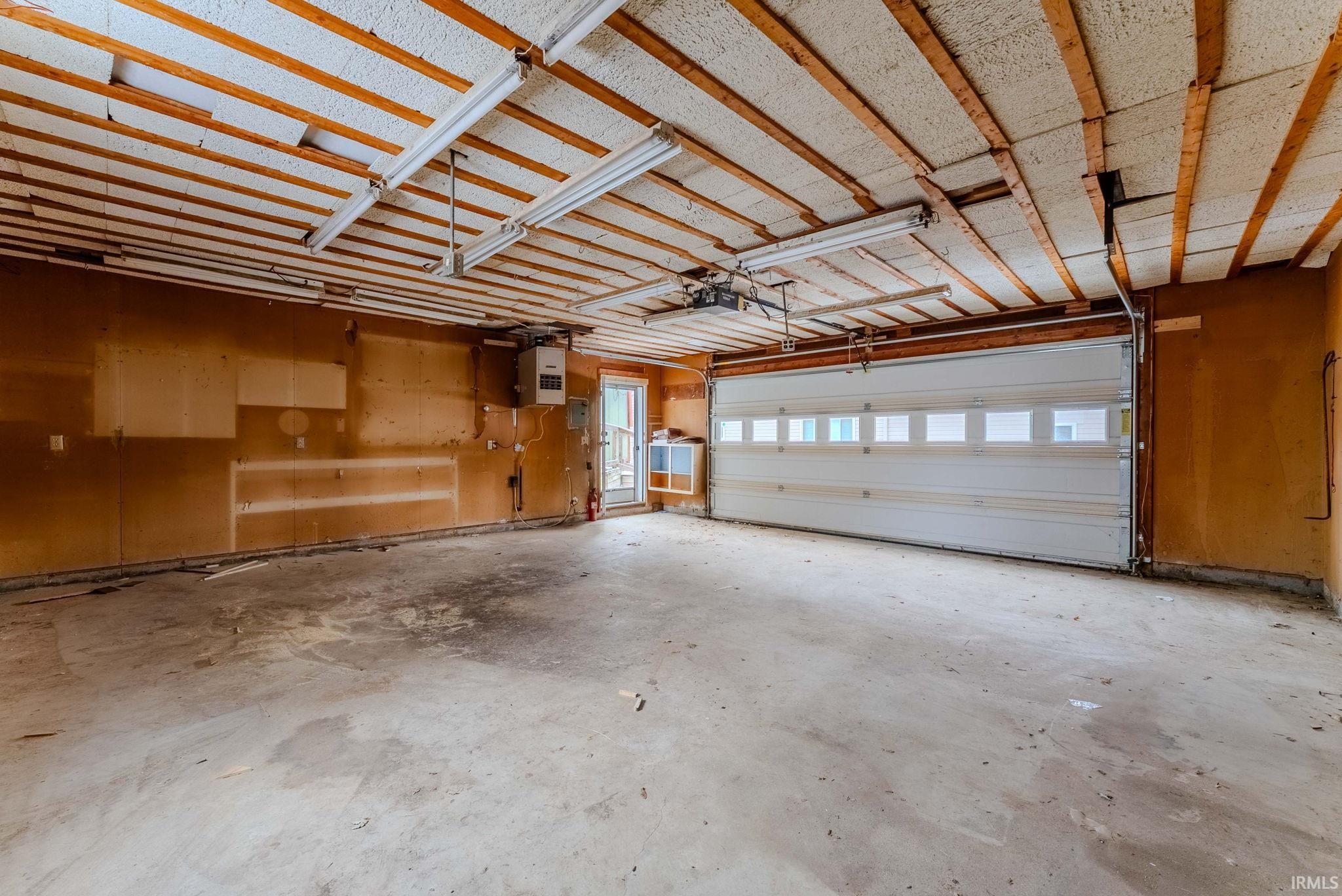 Garage featuring a heating unit