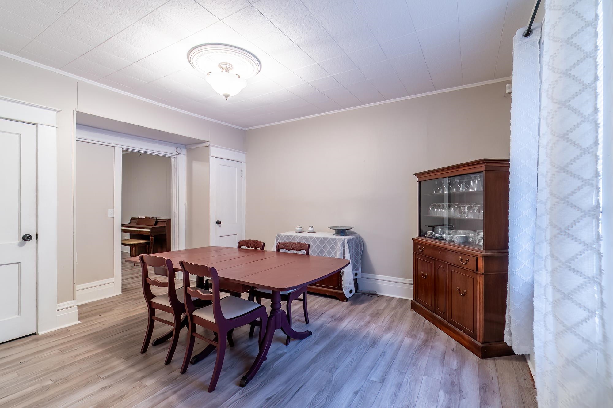 Dining space featuring ornamental molding and light wood finished floors