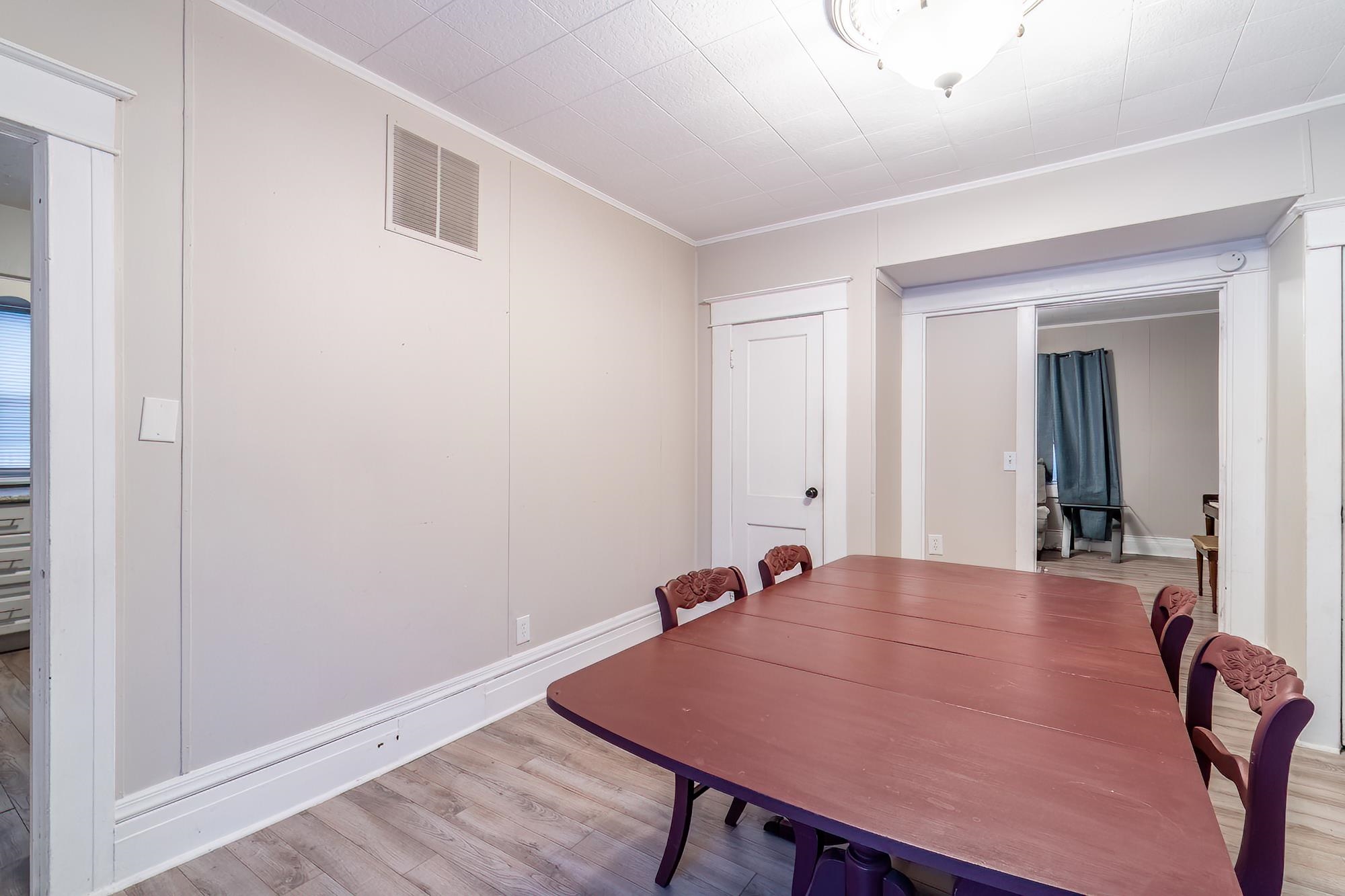Dining room with light wood-style floors and ornamental molding
