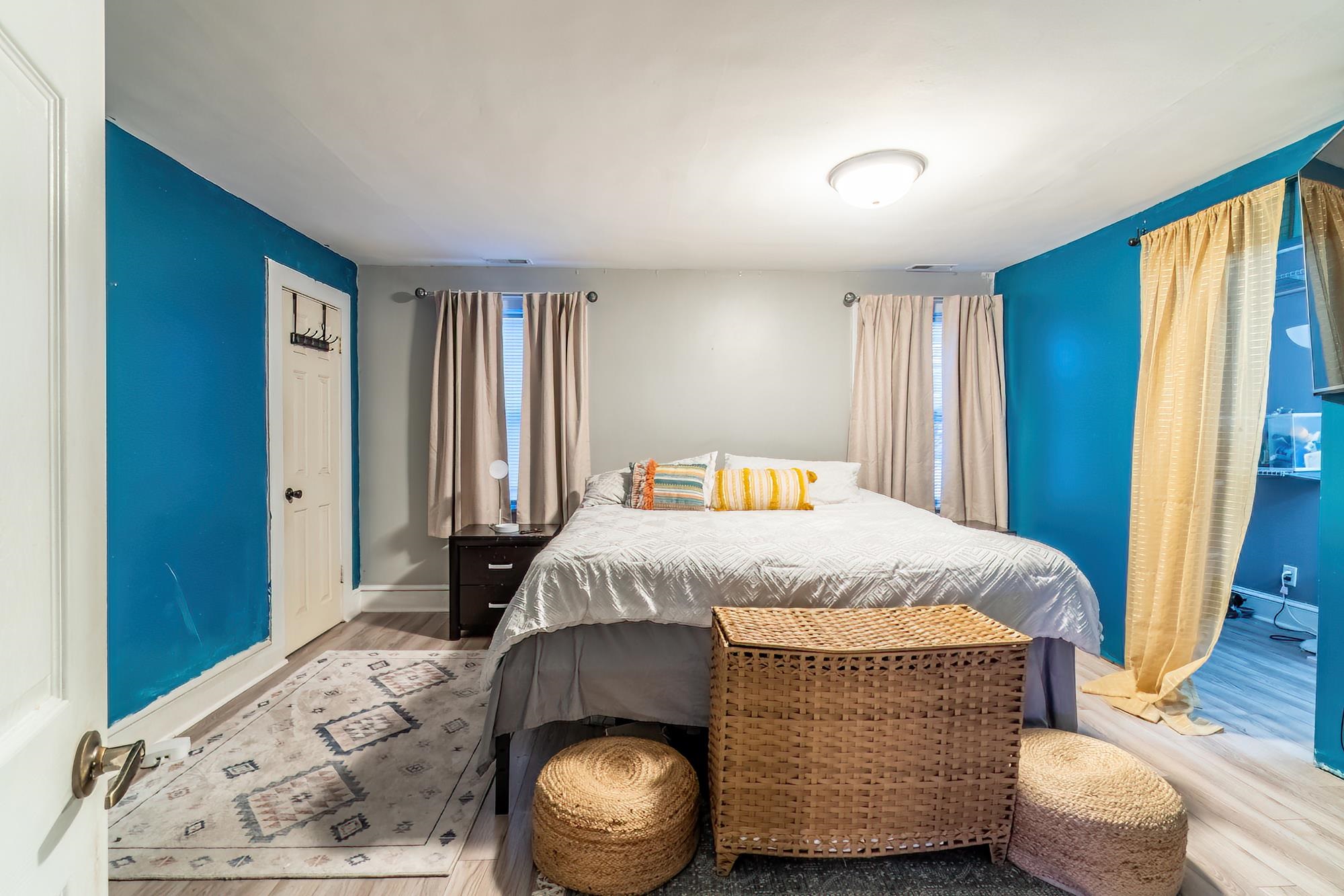 Bedroom featuring wood finished floors and baseboards