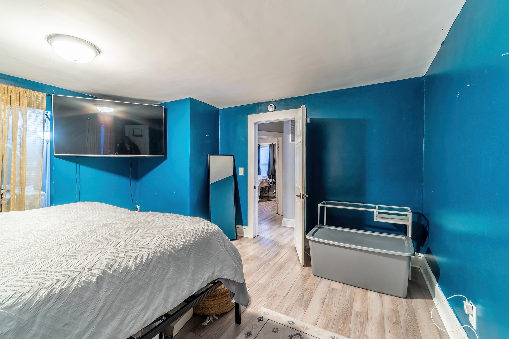 Bedroom featuring wood finished floors and baseboards