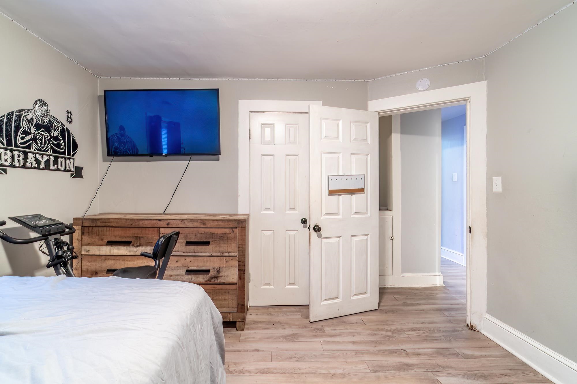 Bedroom featuring wood finished floors and baseboards