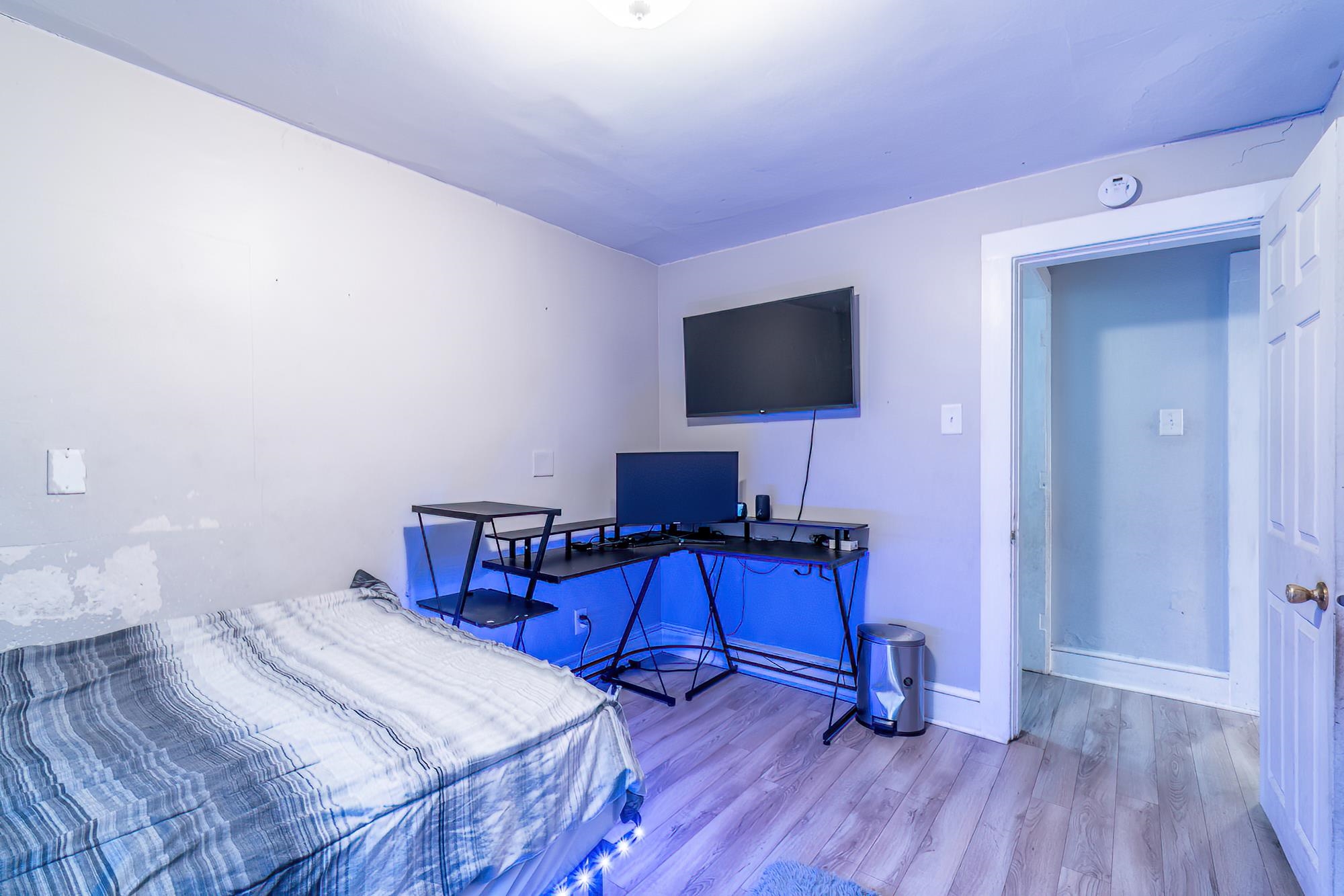 Bedroom with wood finished floors and baseboards