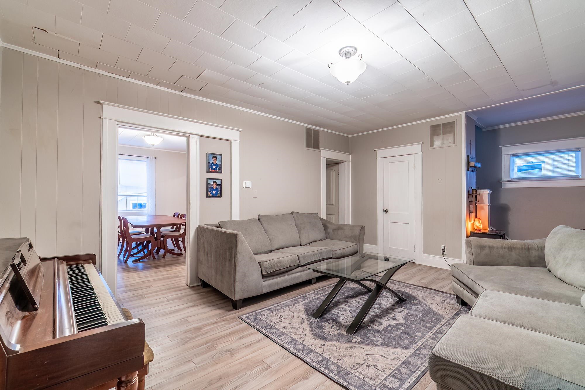 Living area featuring light wood-type flooring and crown molding