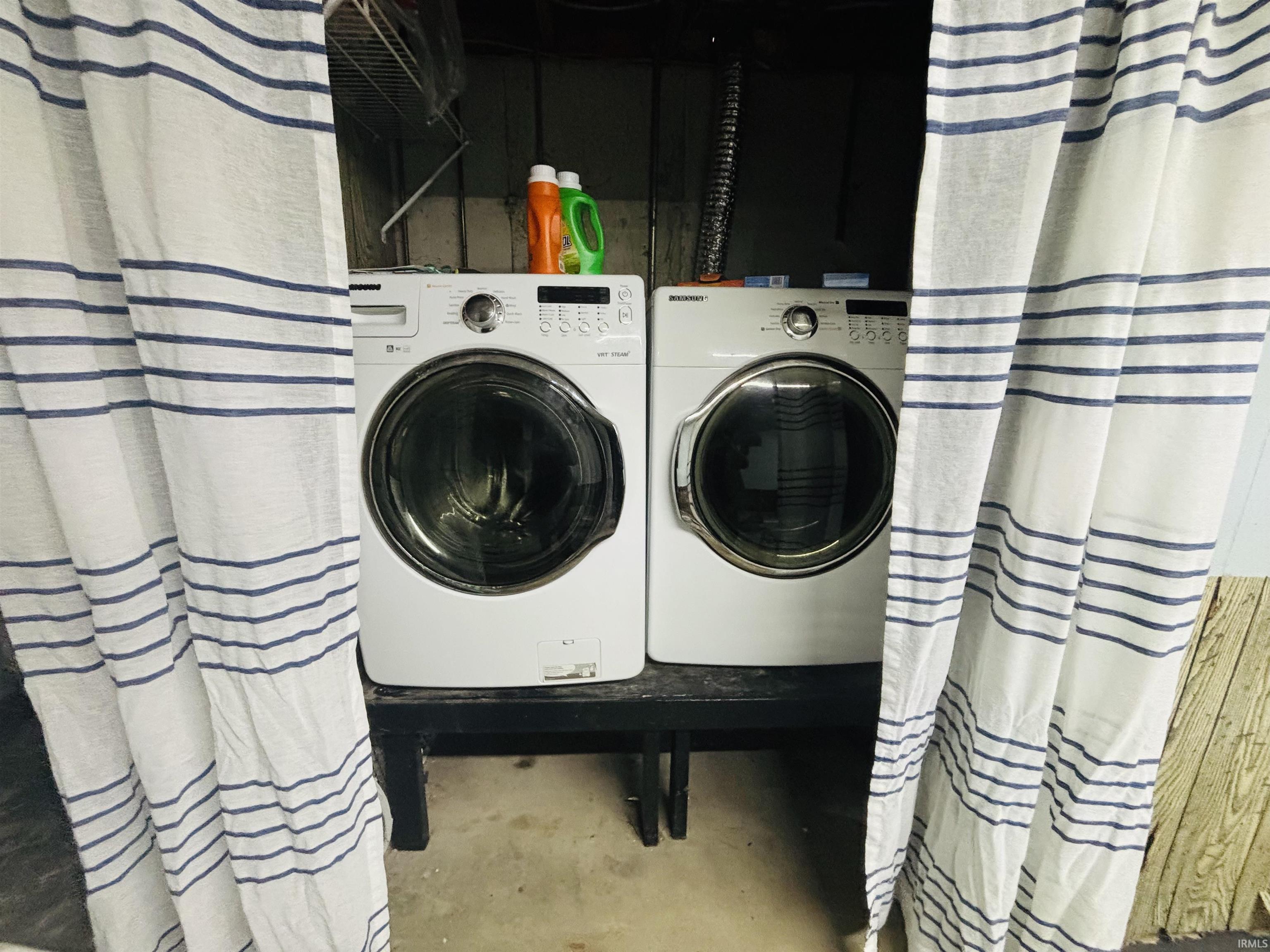Laundry room with concrete flooring and independent washer and dryer