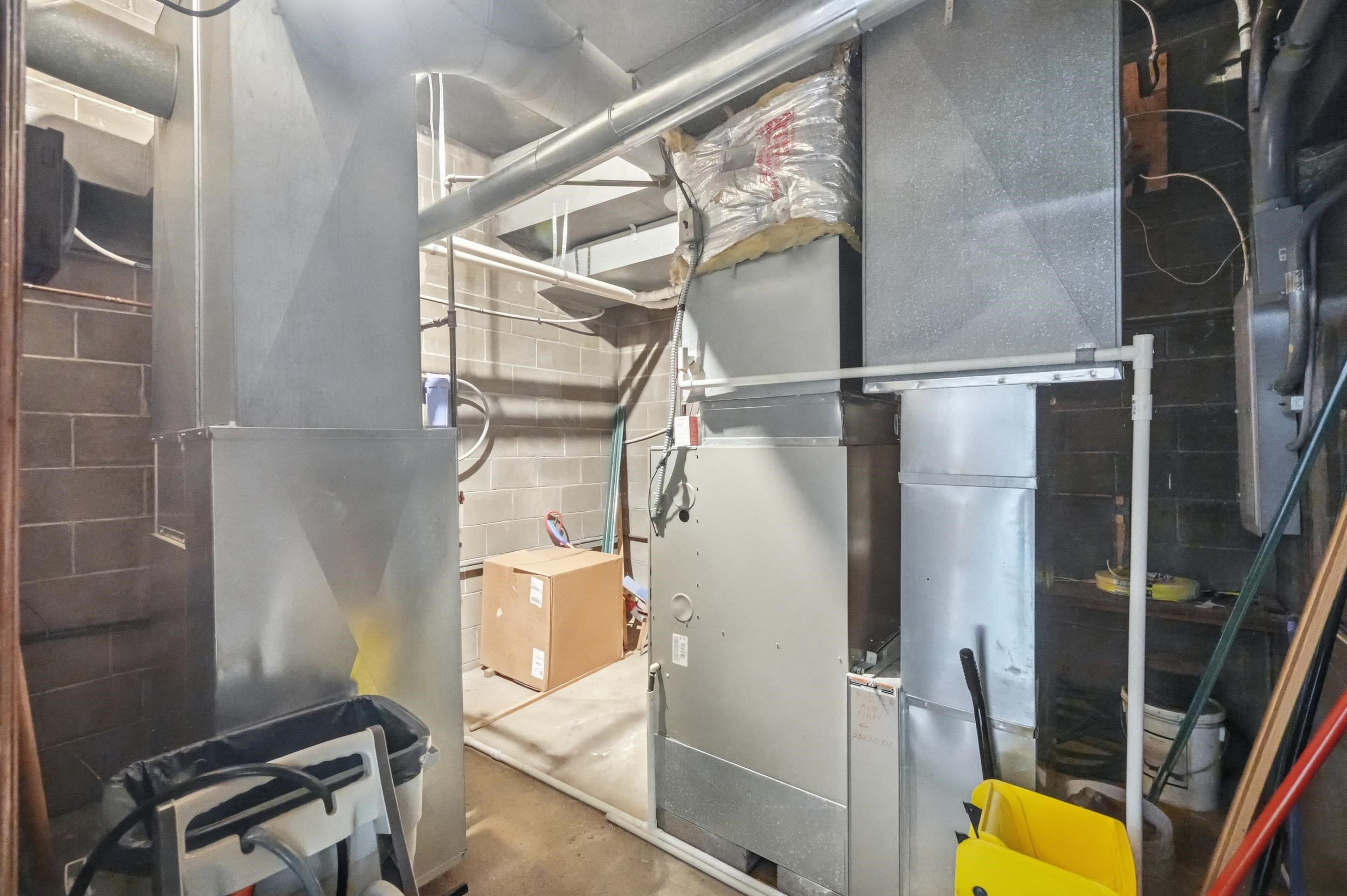 Utility room featuring heating unit
