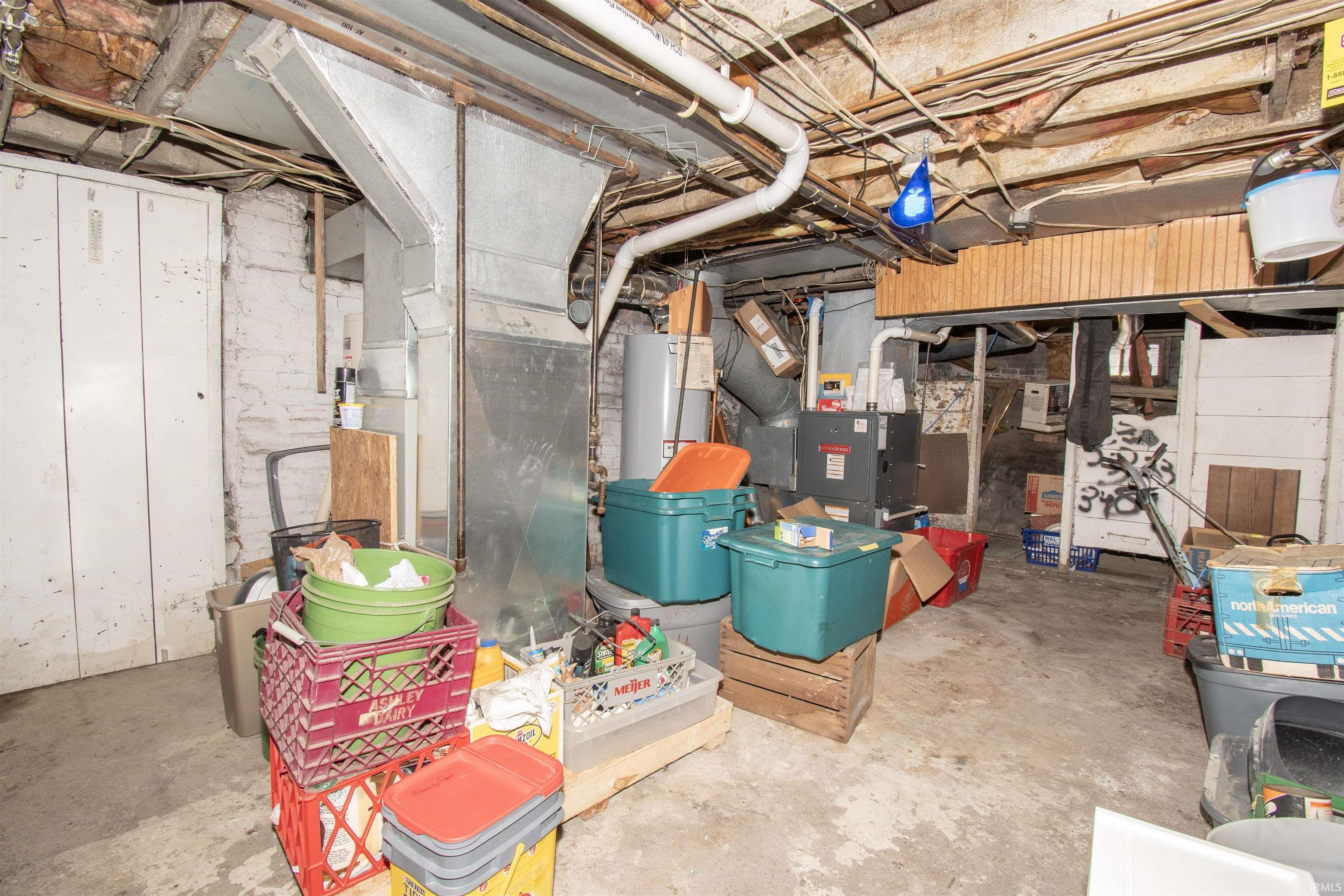 Unfinished basement with water heater and heating unit