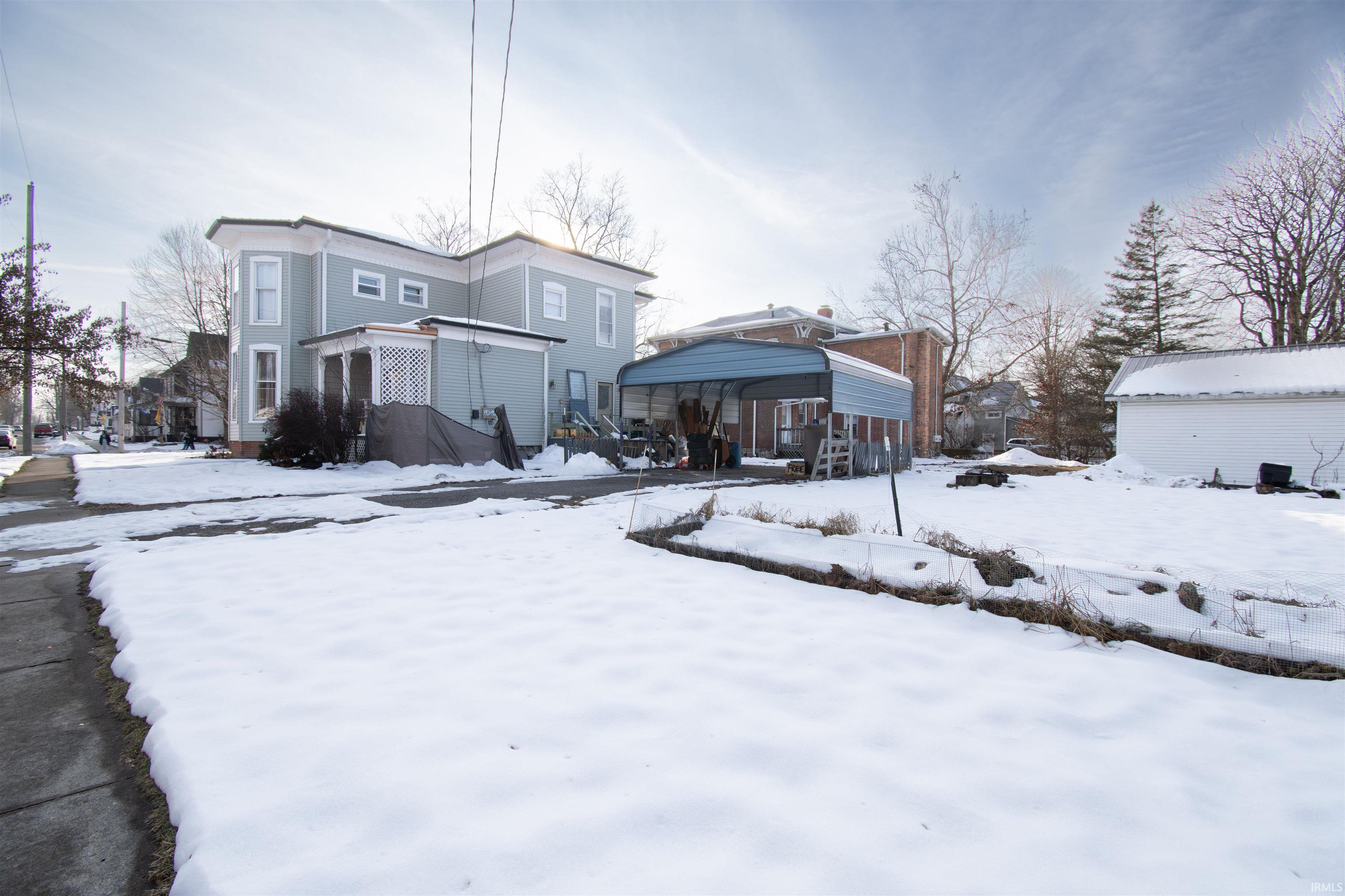 View of snow covered rear of property