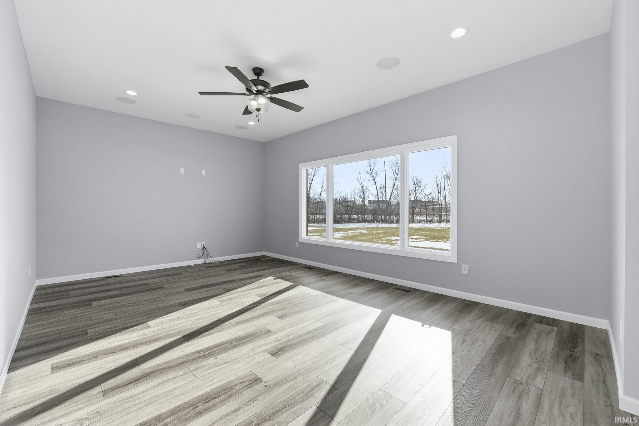 Spare room with light wood-style floors, recessed lighting, and a ceiling fan