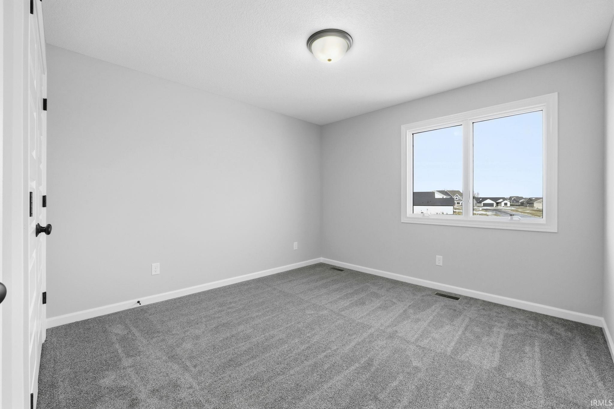 Unfurnished room featuring light carpet