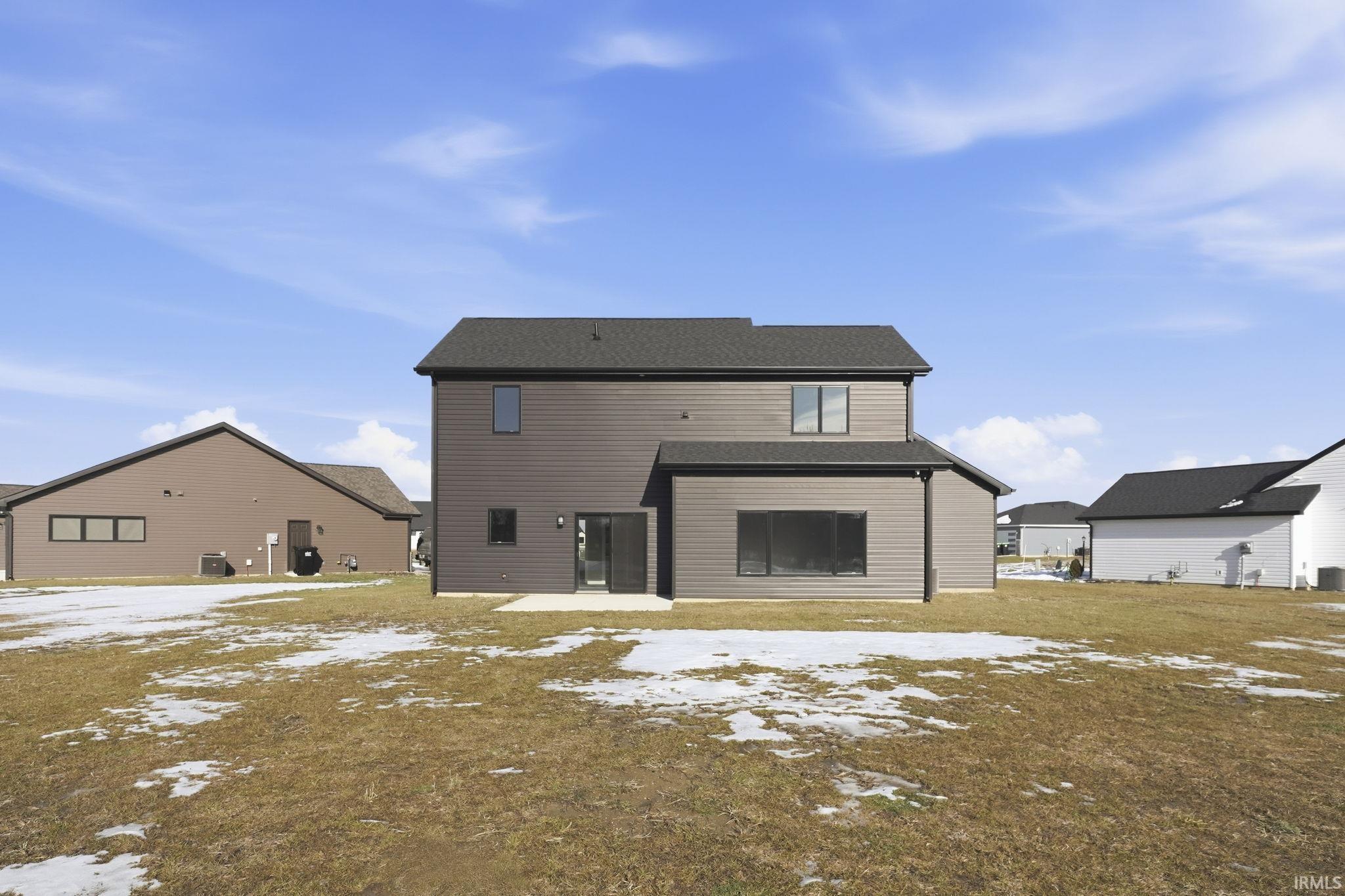 View of snow covered back of property