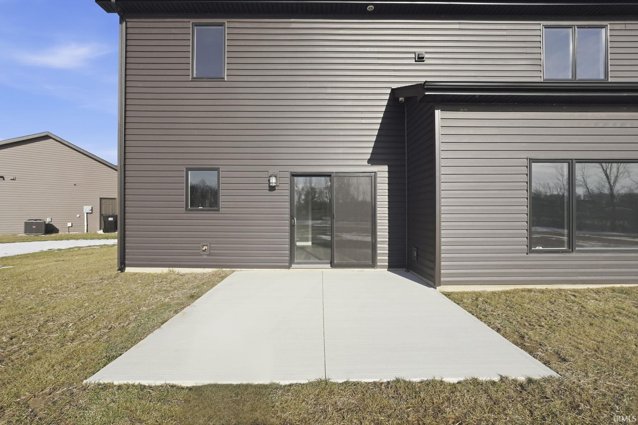 Rear view of house with a lawn