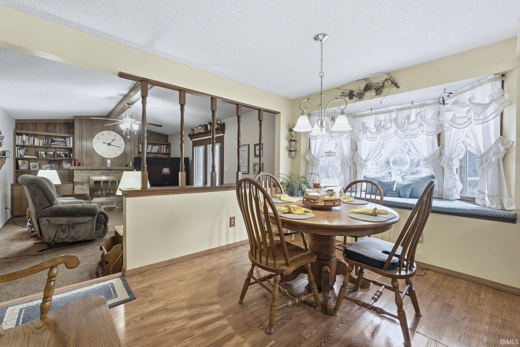 Dining space featuring a textured ceiling and wood finished floors