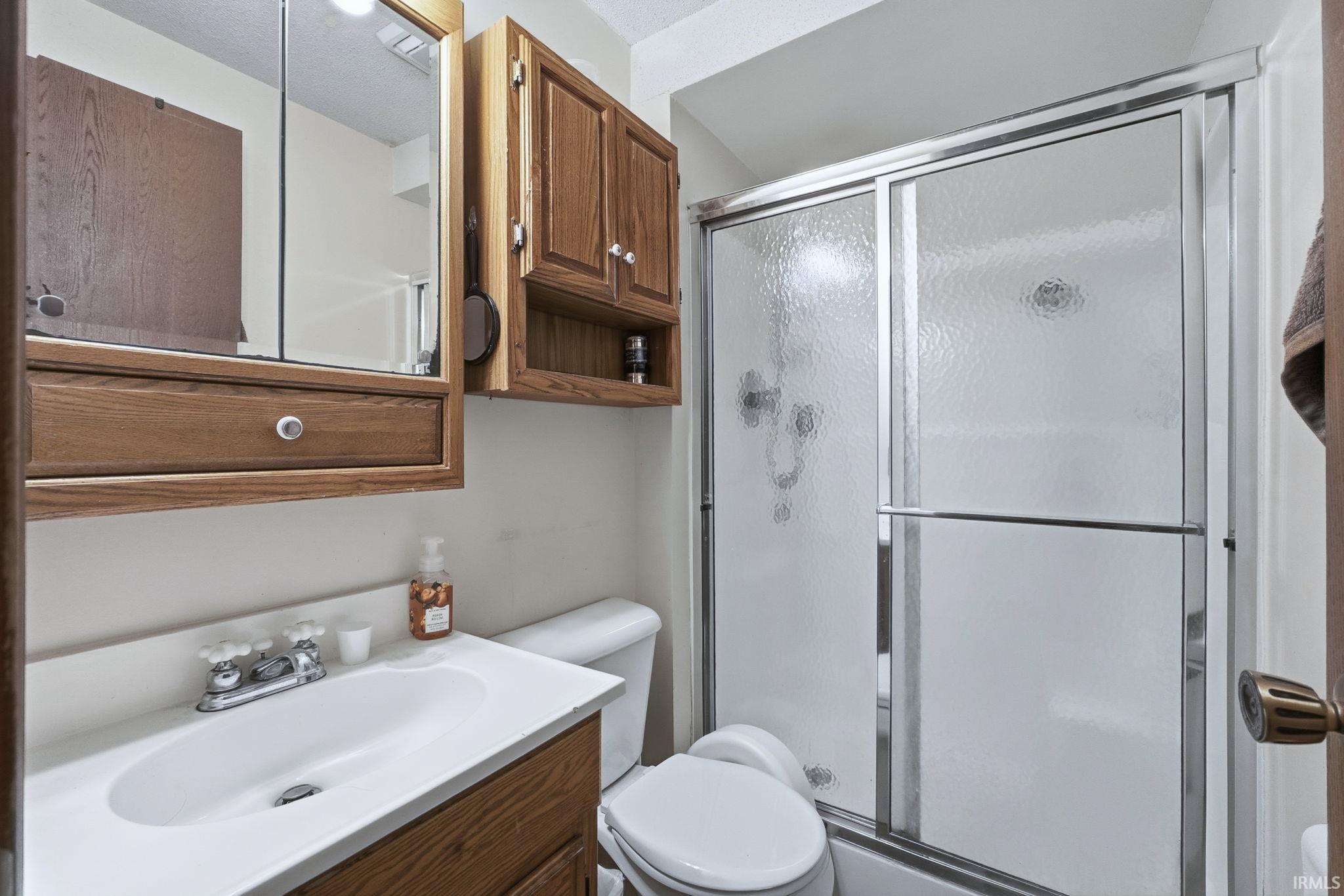 Bathroom with vanity and a shower stall