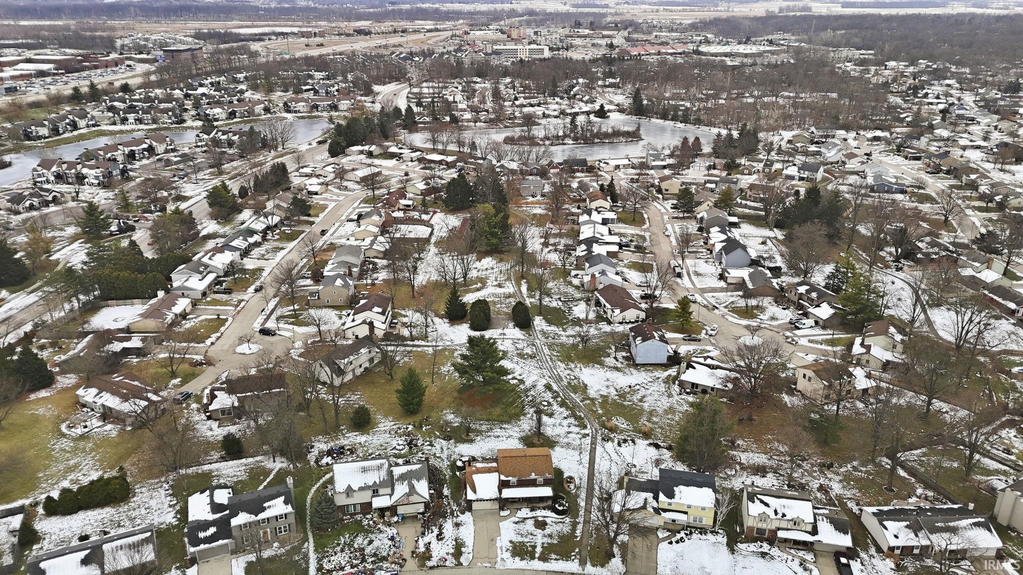 Snowy aerial view featuring a residential view