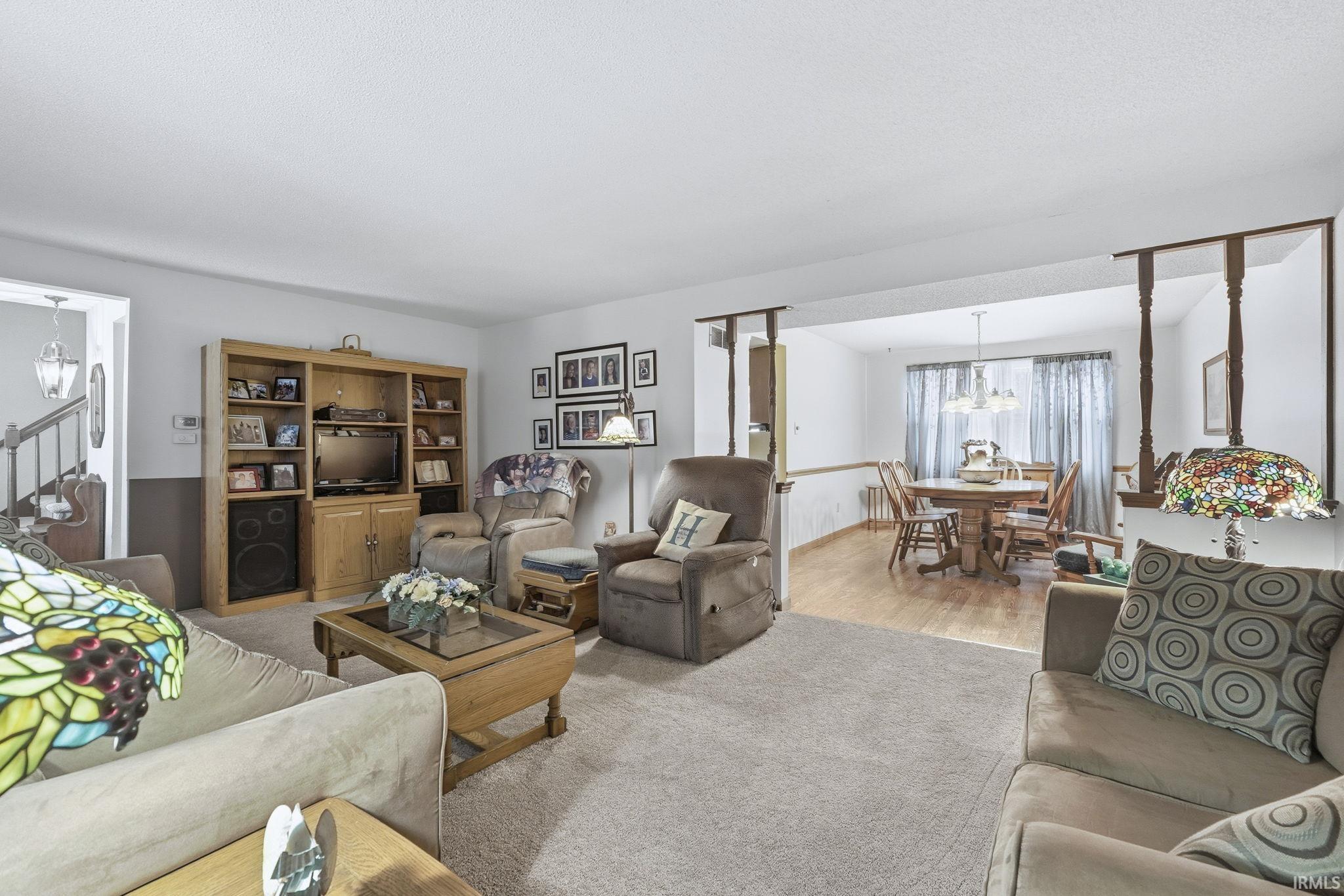 Living room with a chandelier and stairway