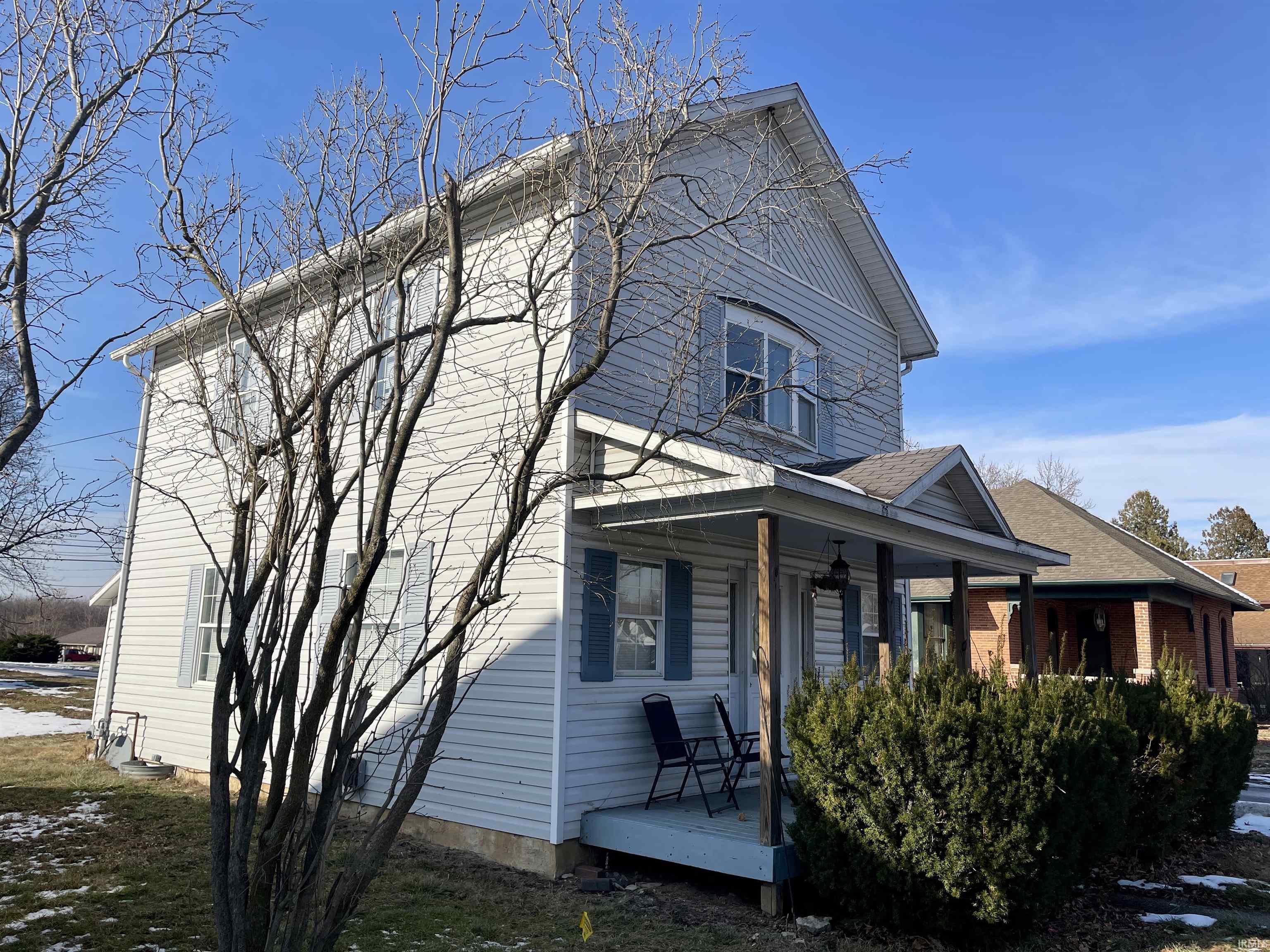 View of property exterior featuring covered porch