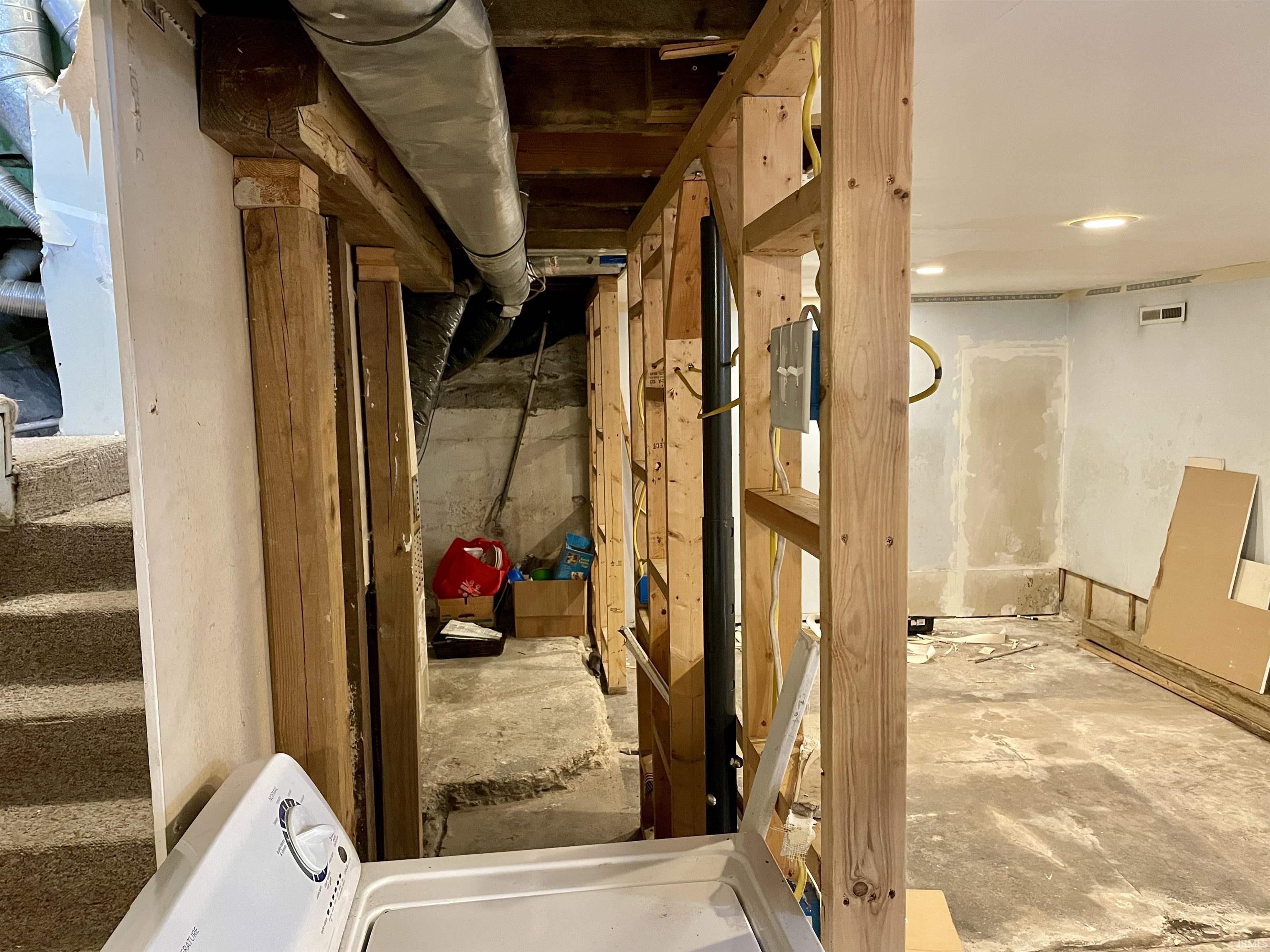Unfinished basement with washer / clothes dryer