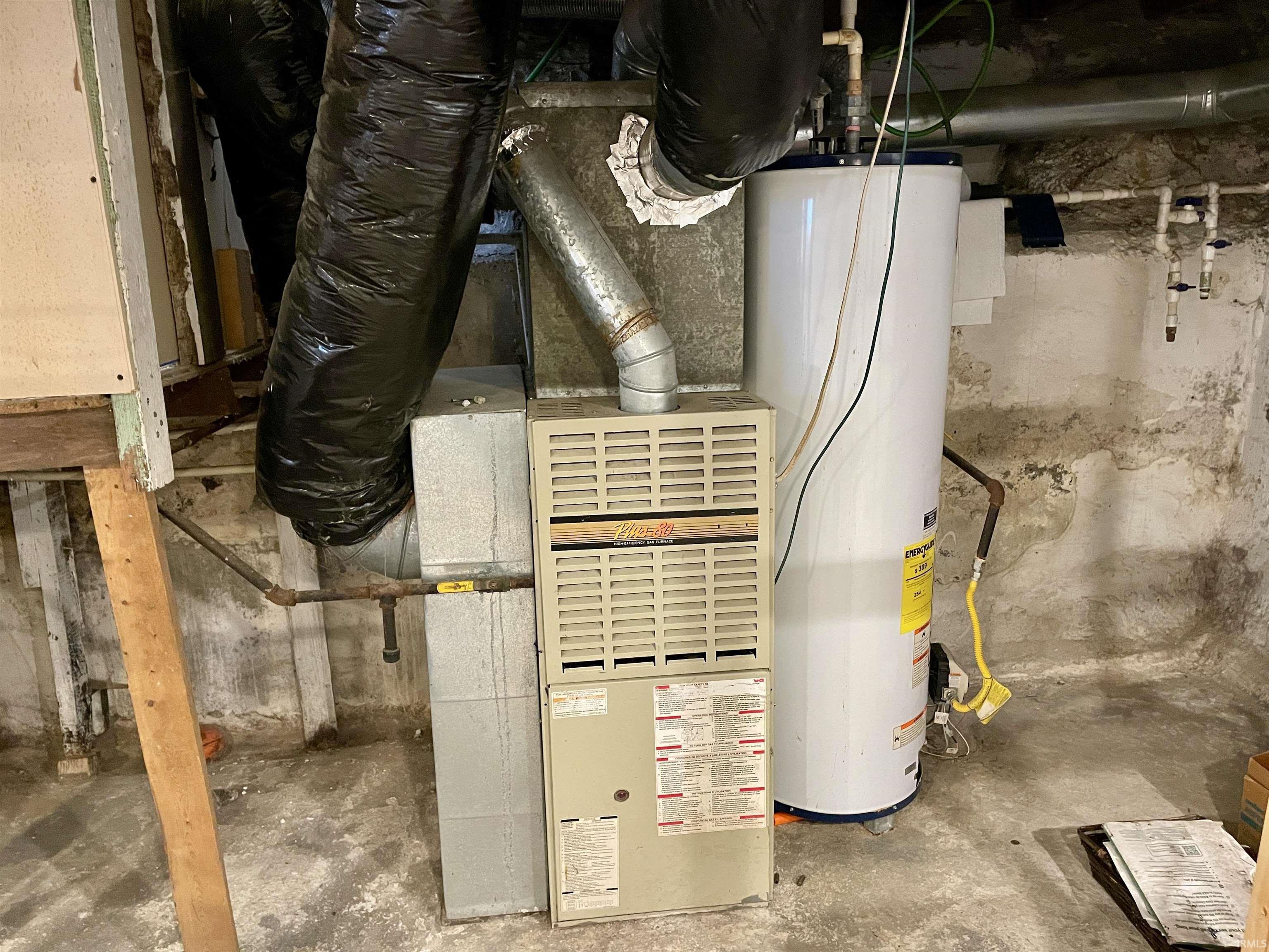 Utility room with water heater and heating unit