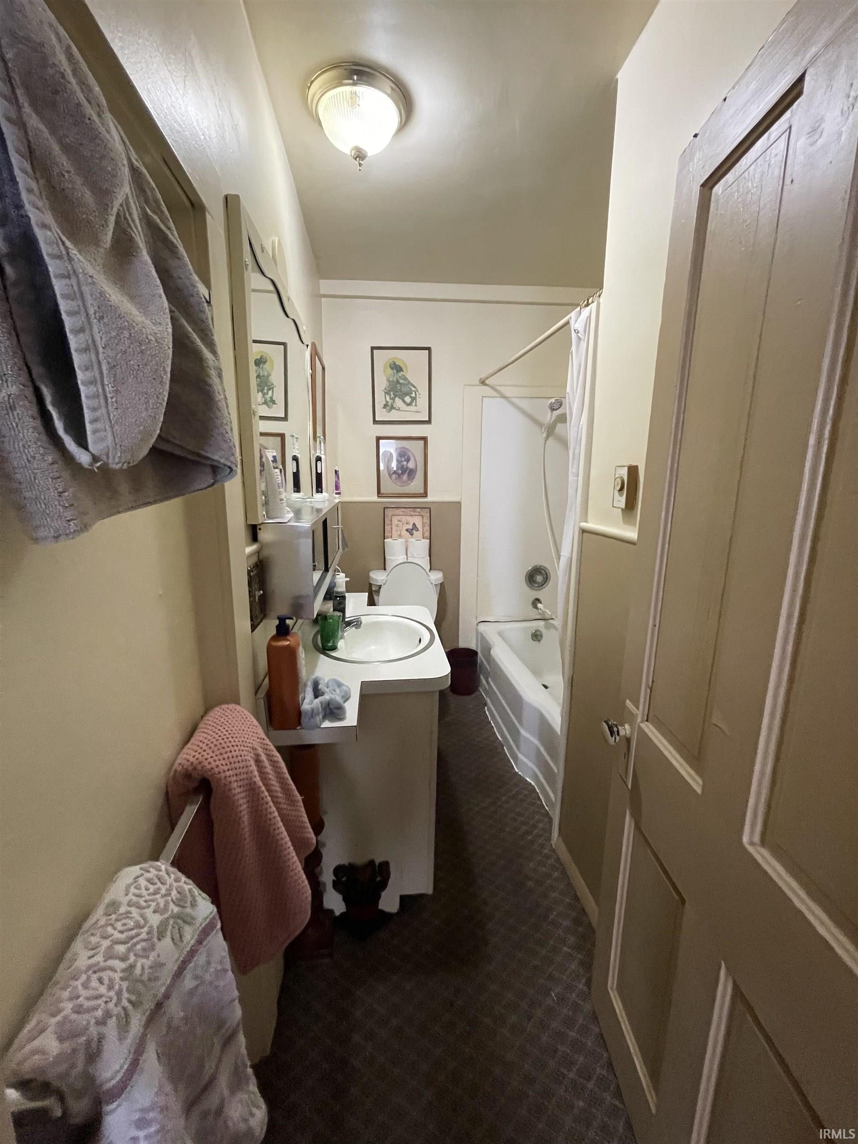 Full bathroom with vanity and shower / bath combo with shower curtain