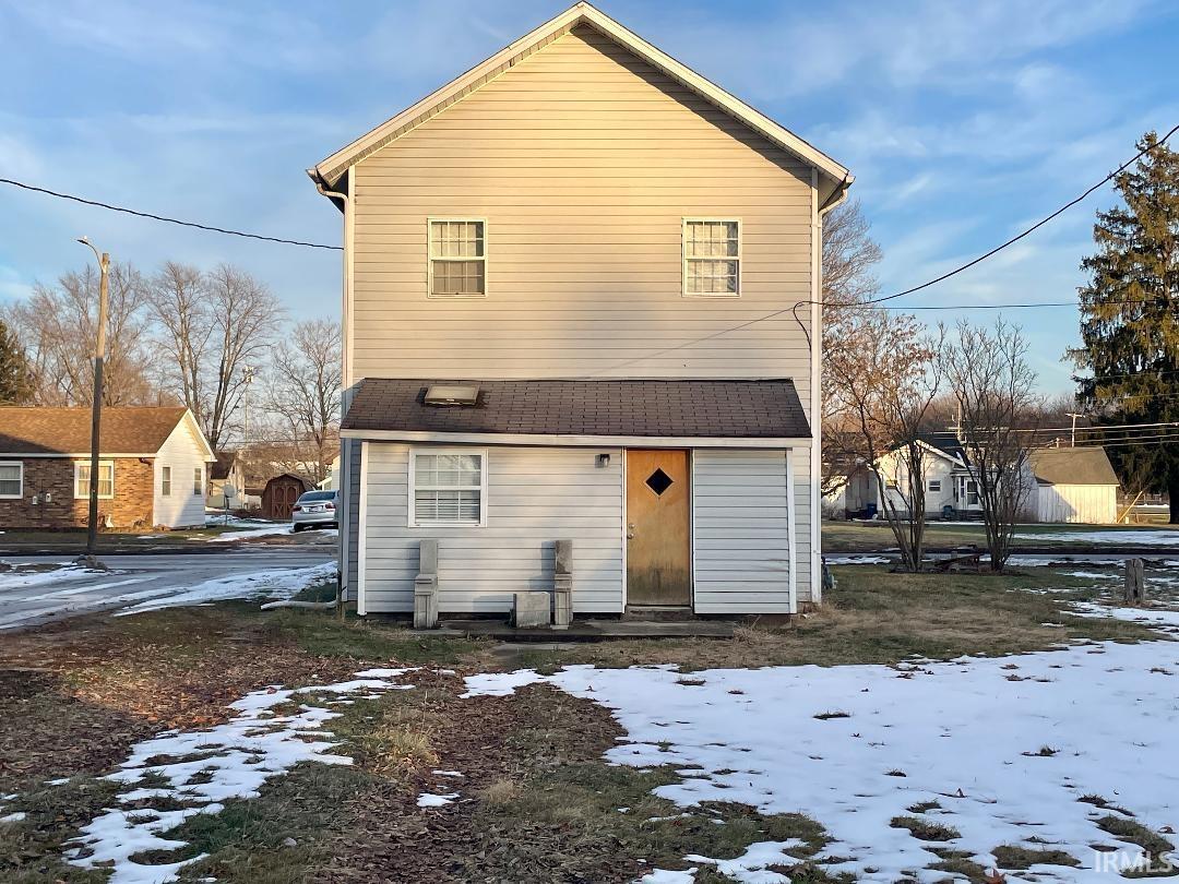 Snow covered house with a shingled roof