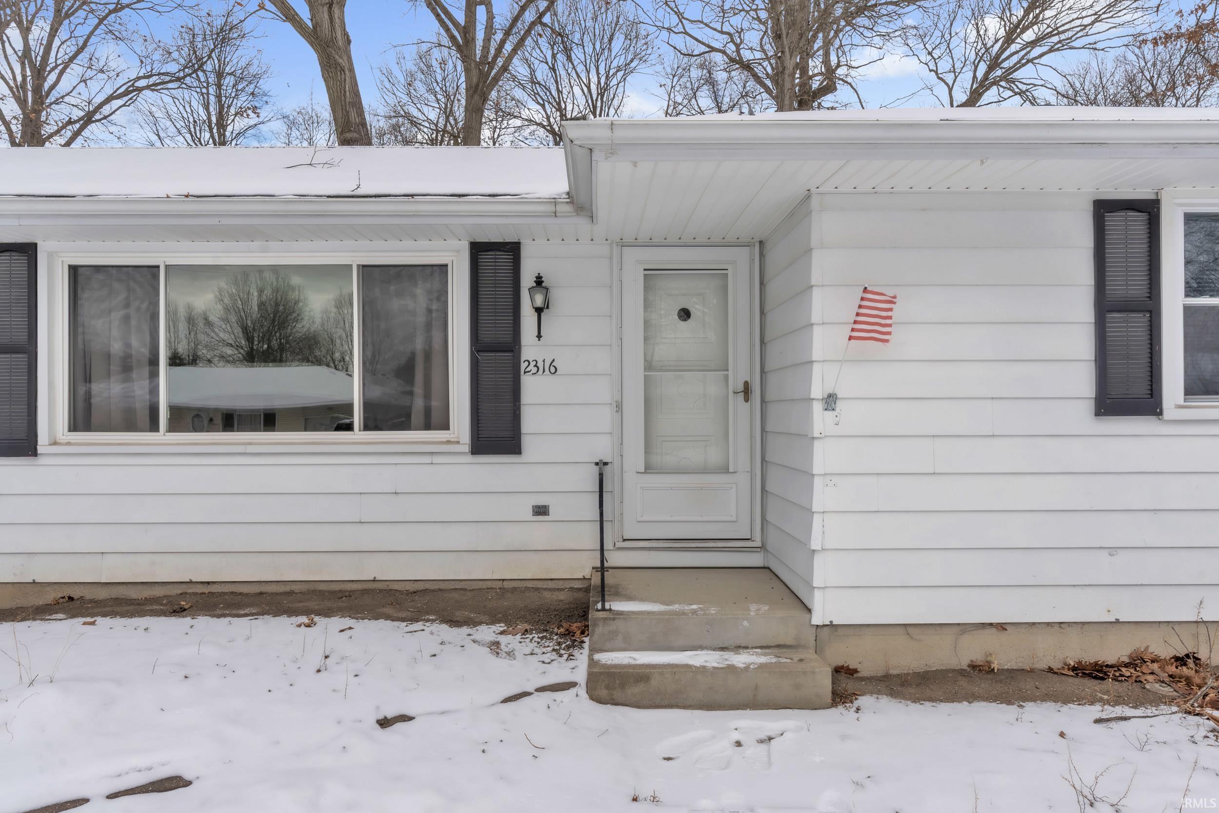 View of snow covered property entrance