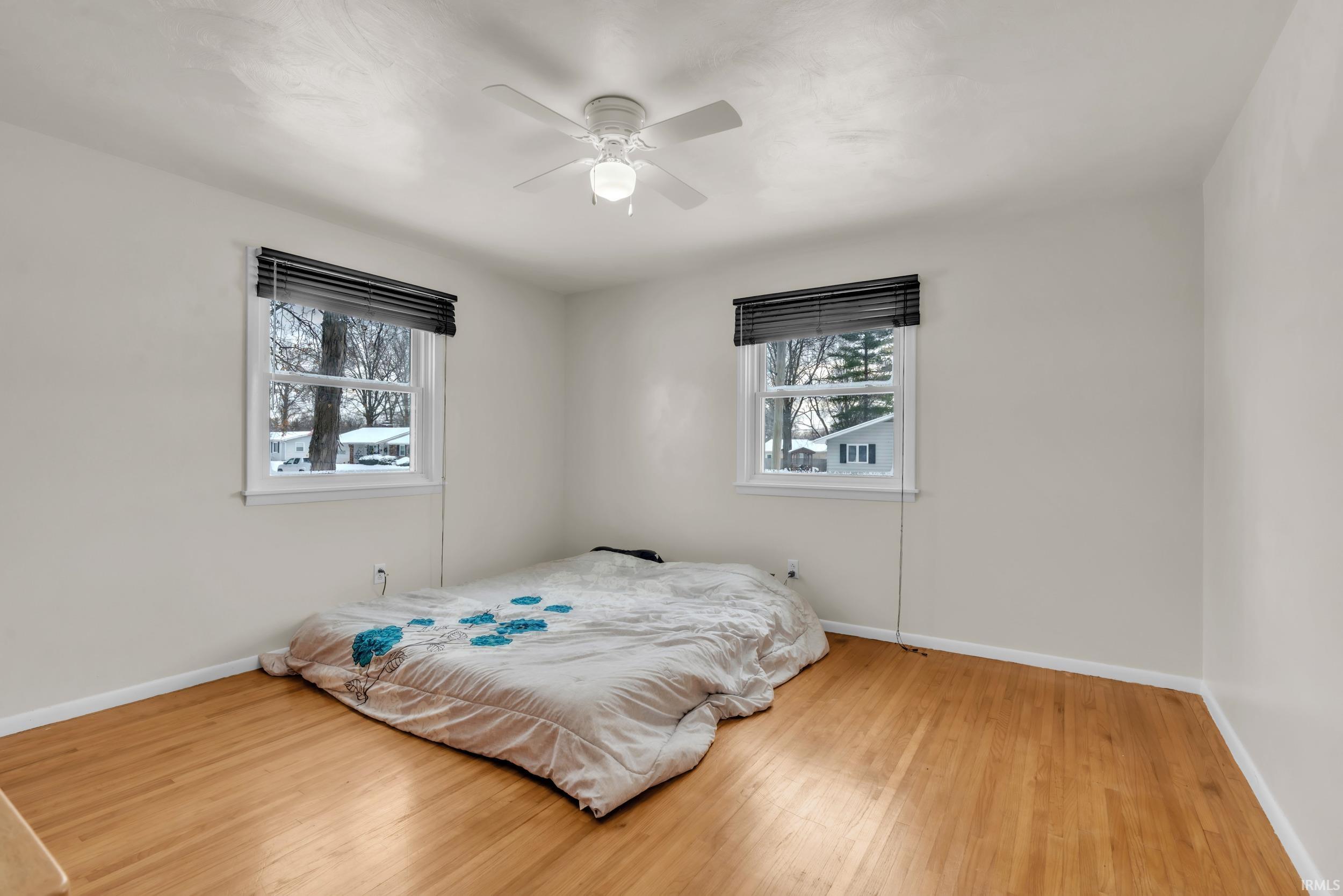 Bedroom featuring light wood finished floors and ceiling fan