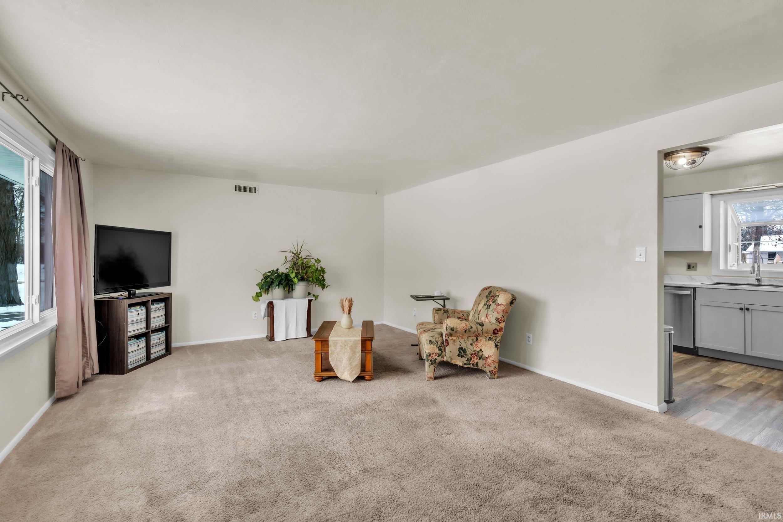 Living area with light carpet