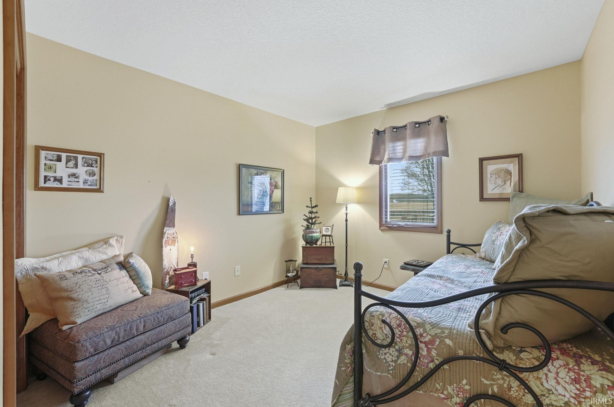 Bedroom featuring carpet flooring and a textured ceiling