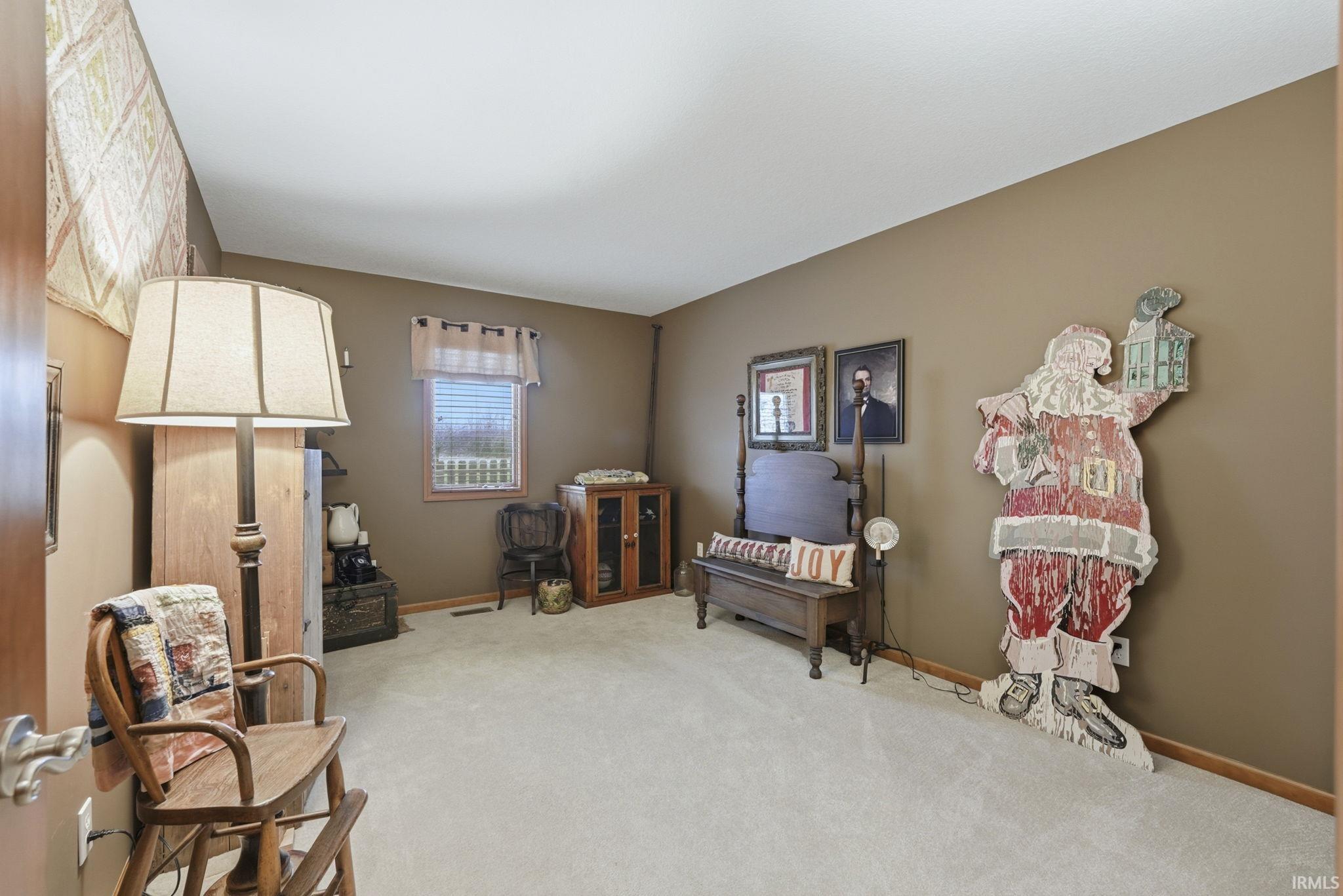 Living area featuring carpet and baseboards