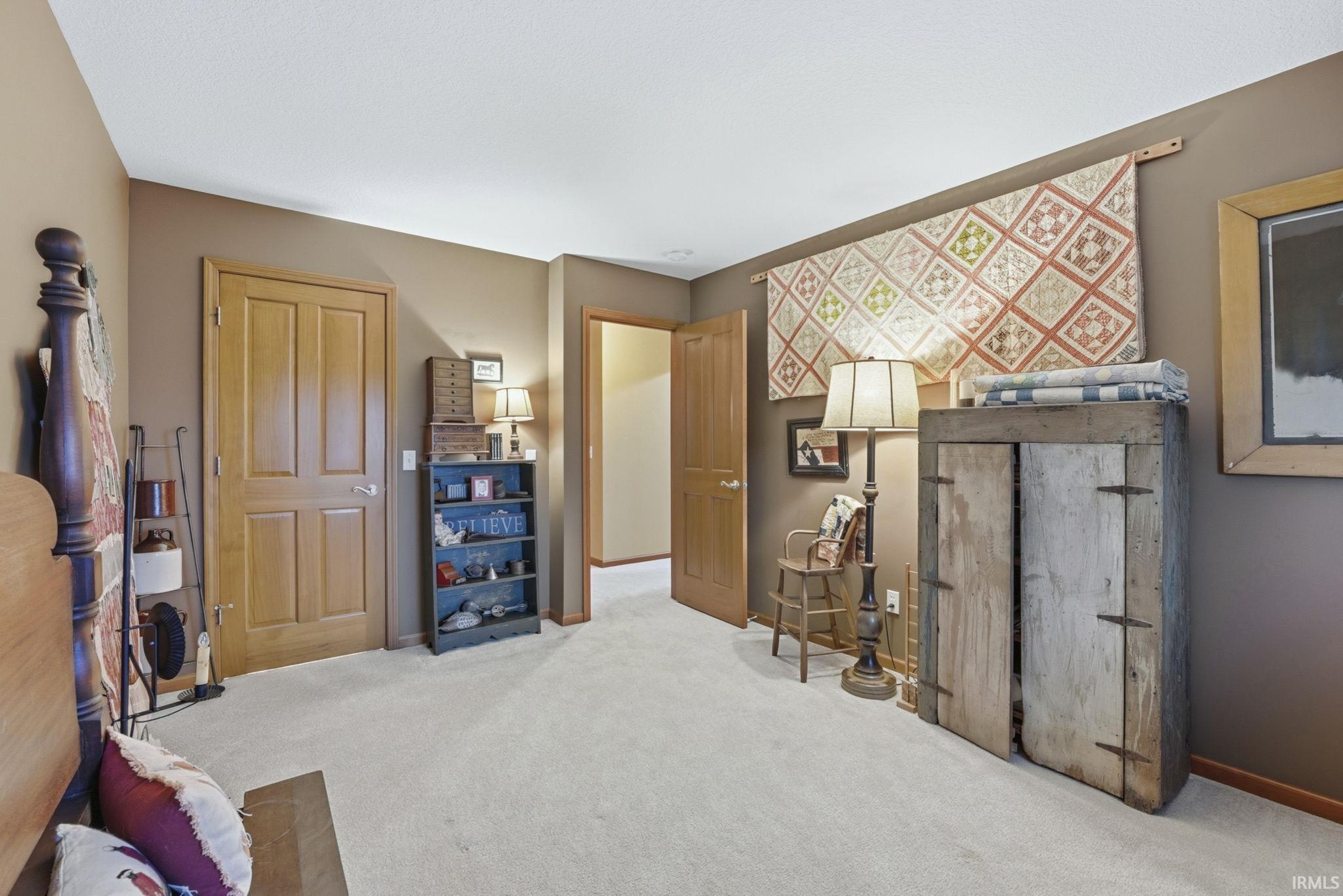 Sitting room featuring carpet and baseboards