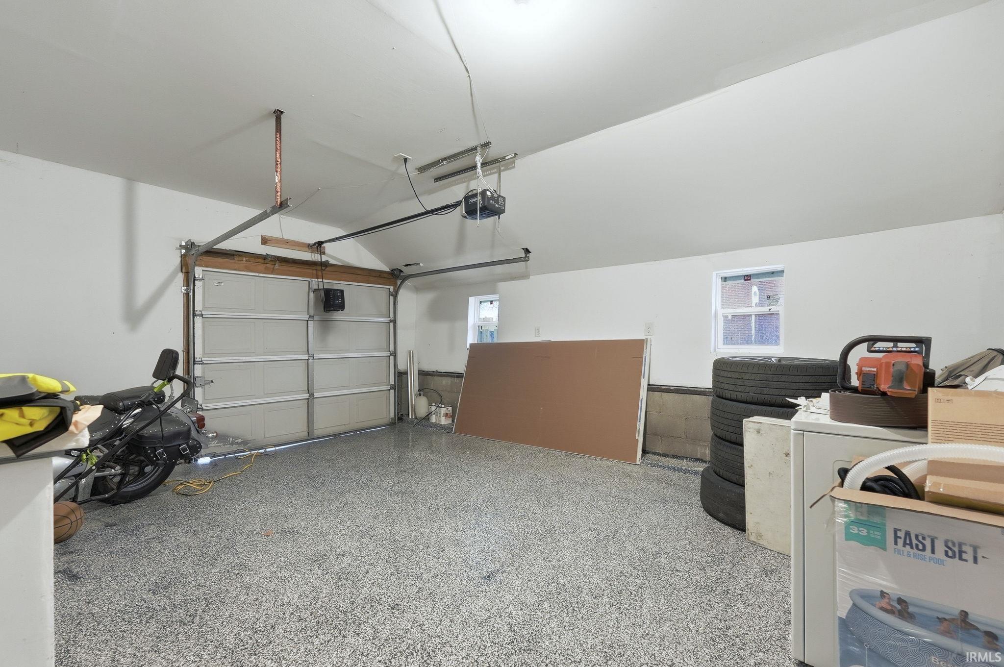 Garage featuring washer / dryer and a garage door opener