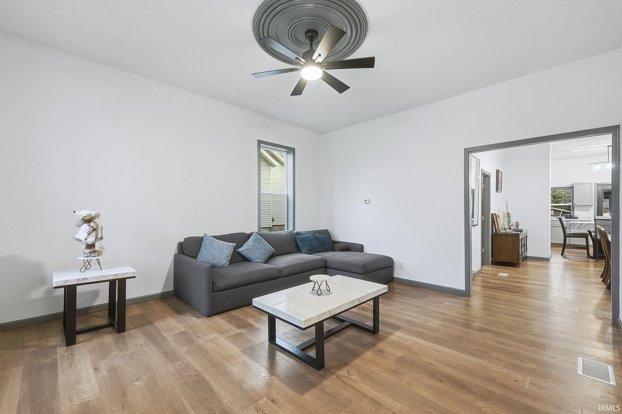 Living area featuring light wood finished floors and baseboards