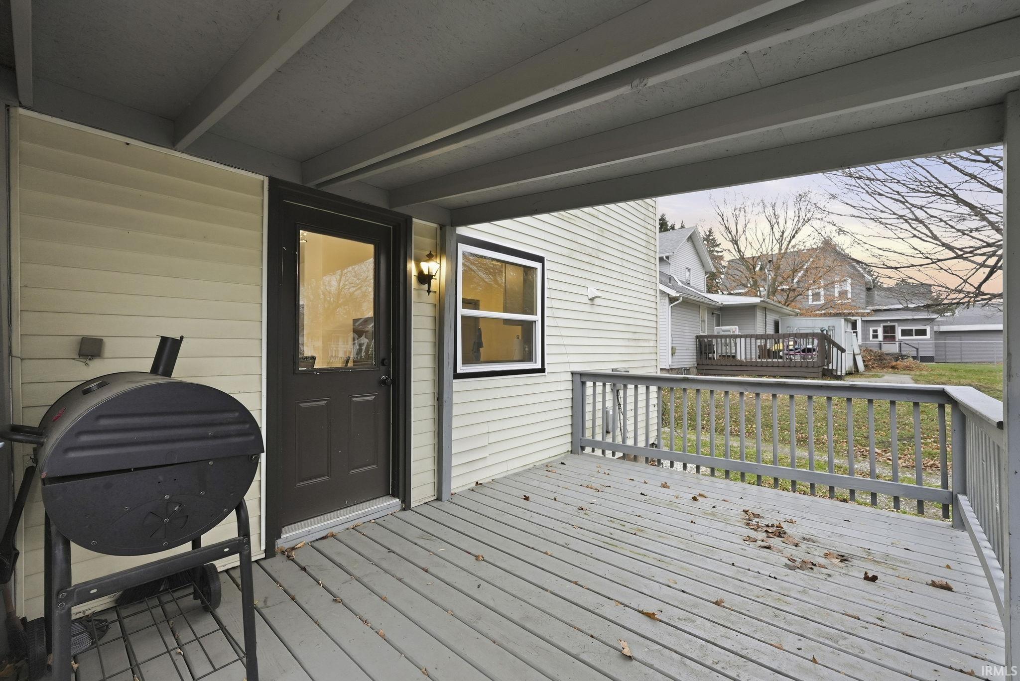Wooden deck featuring grilling area and a residential view
