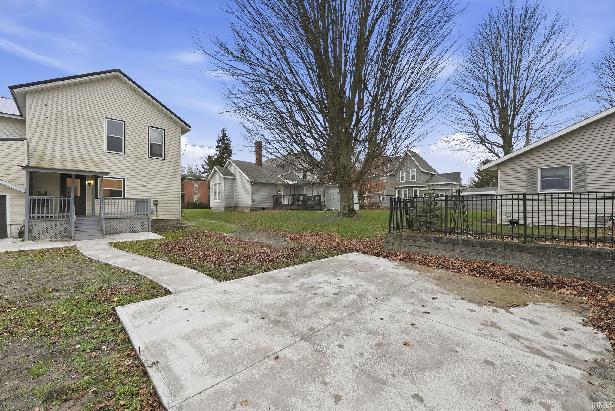 View of grassy yard with a residential view and a patio